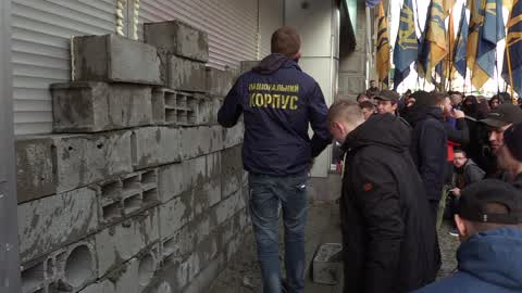 Ukrainian activists build a wall which block entrance to the Sberbank of Russia in Kiev