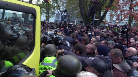 Activists clash with riot policemen during a protest in Kiev