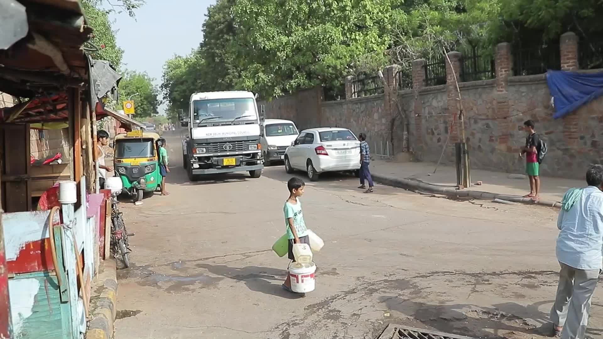 Local residents fill their containers in New Delhi