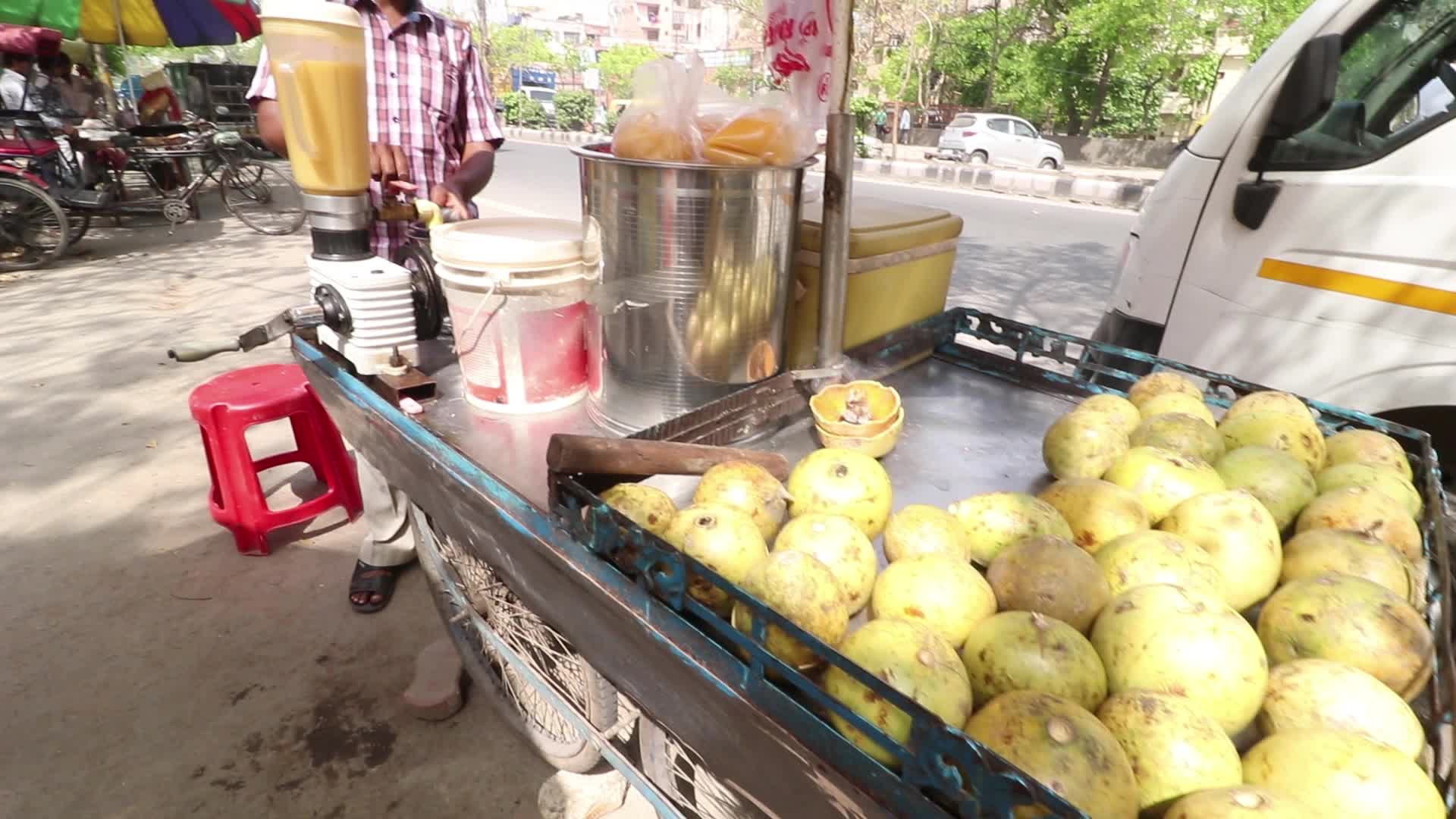 A juice maker preparing summer drink by the road side in New Delhi