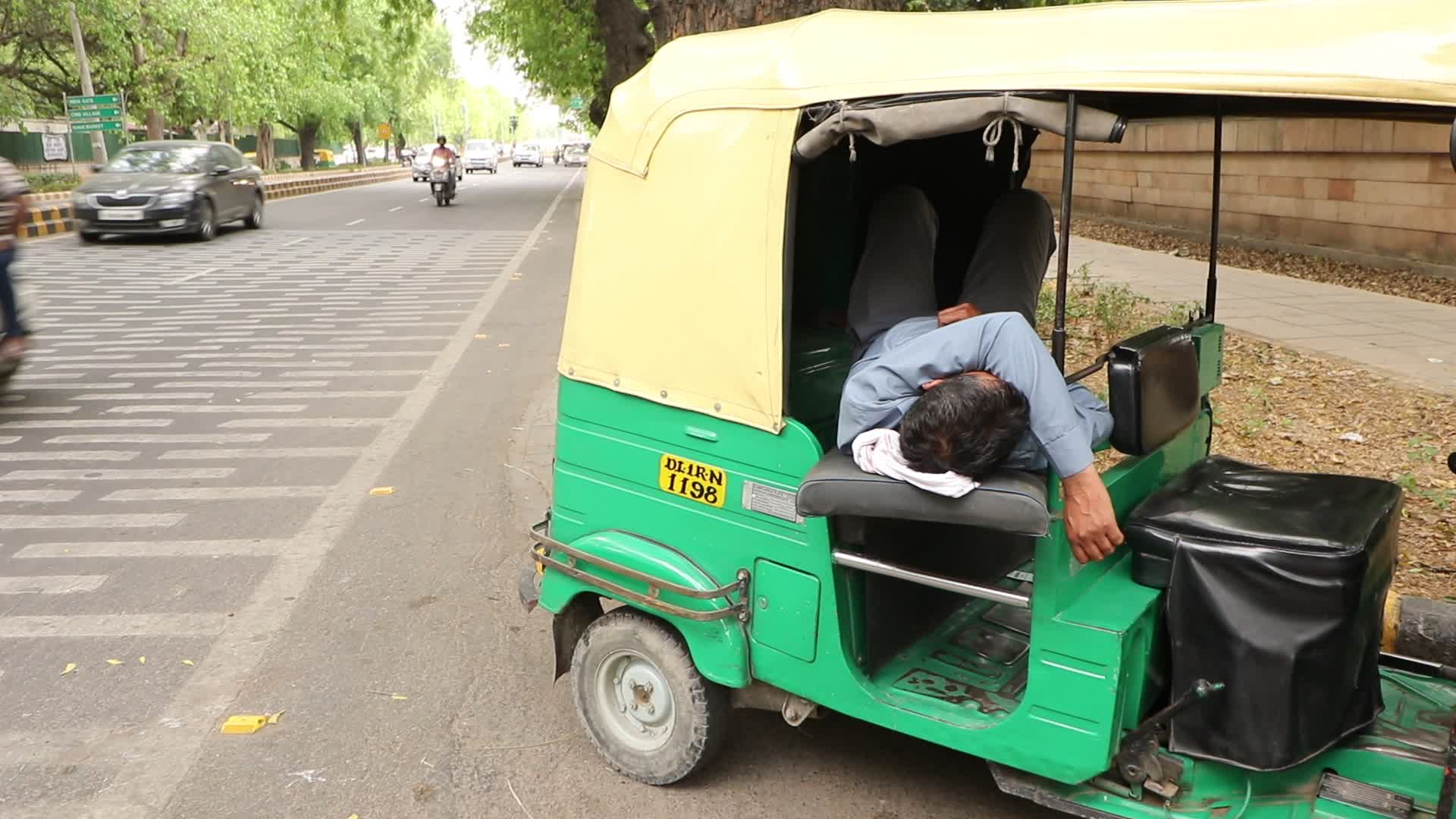 Driver sleeps in auto rickshaw 