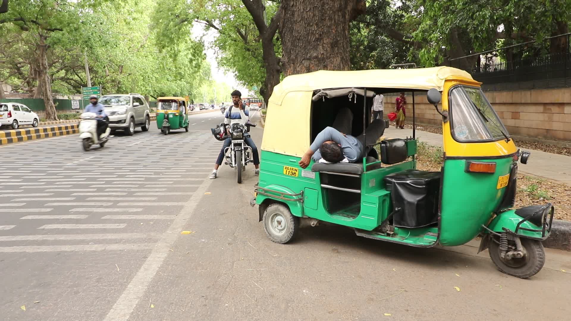 Driver sleeps in auto rickshaw 