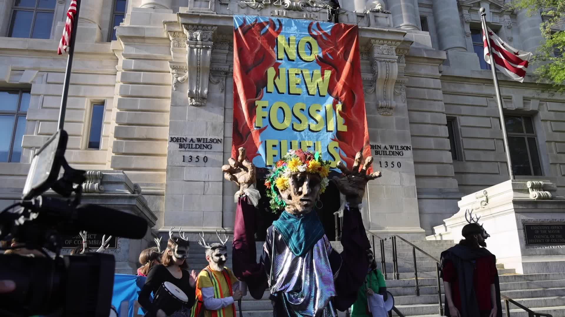 Climate activist scales Wilson Building and drops banner