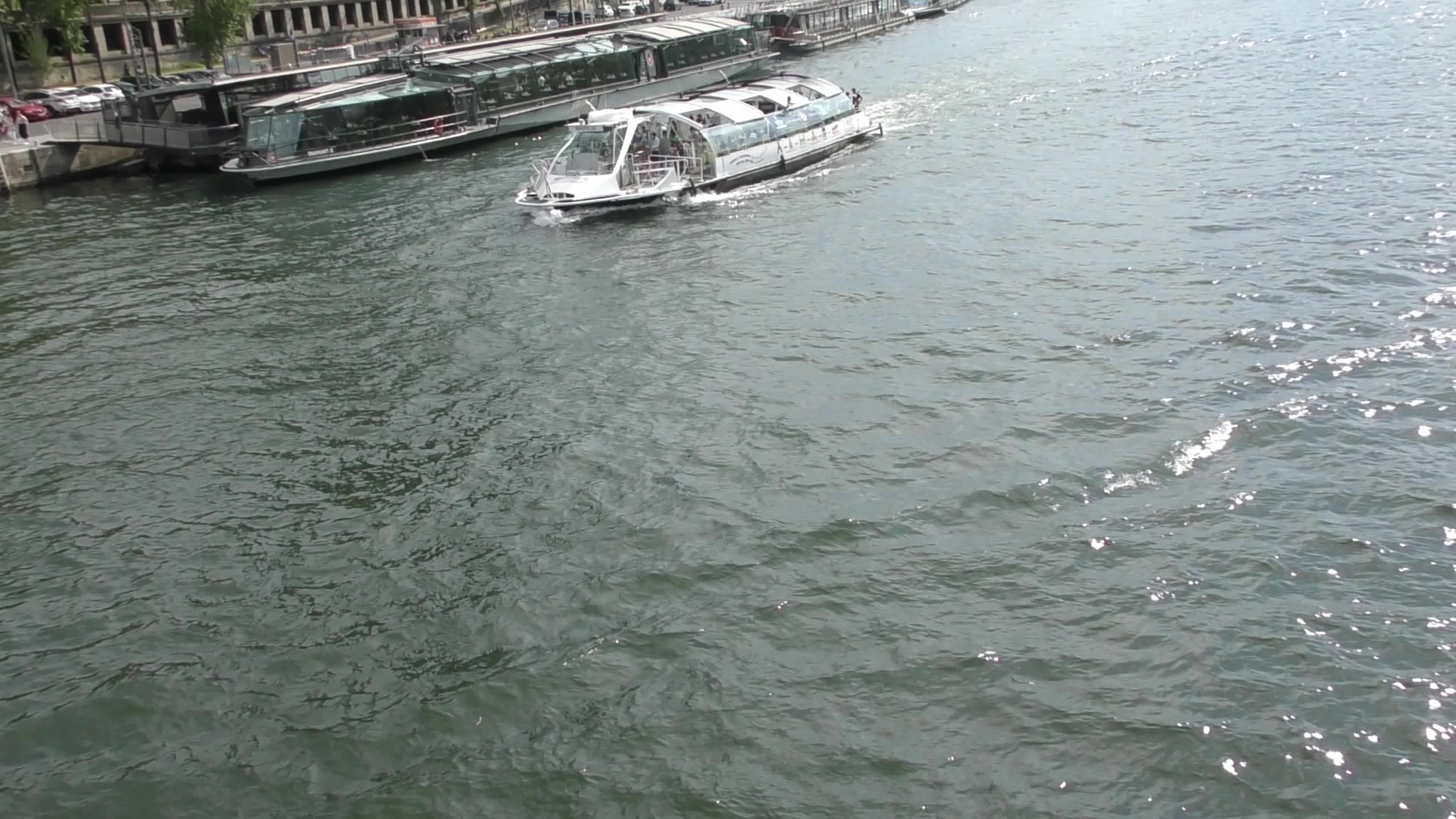 Boats and tourists on river La Seine in Paris