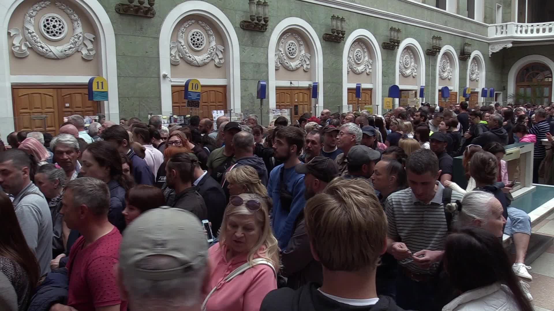 Ukrainians queue to buy a new set of postal service stamps dedicated to the sinking of Russian warship, in Odesa