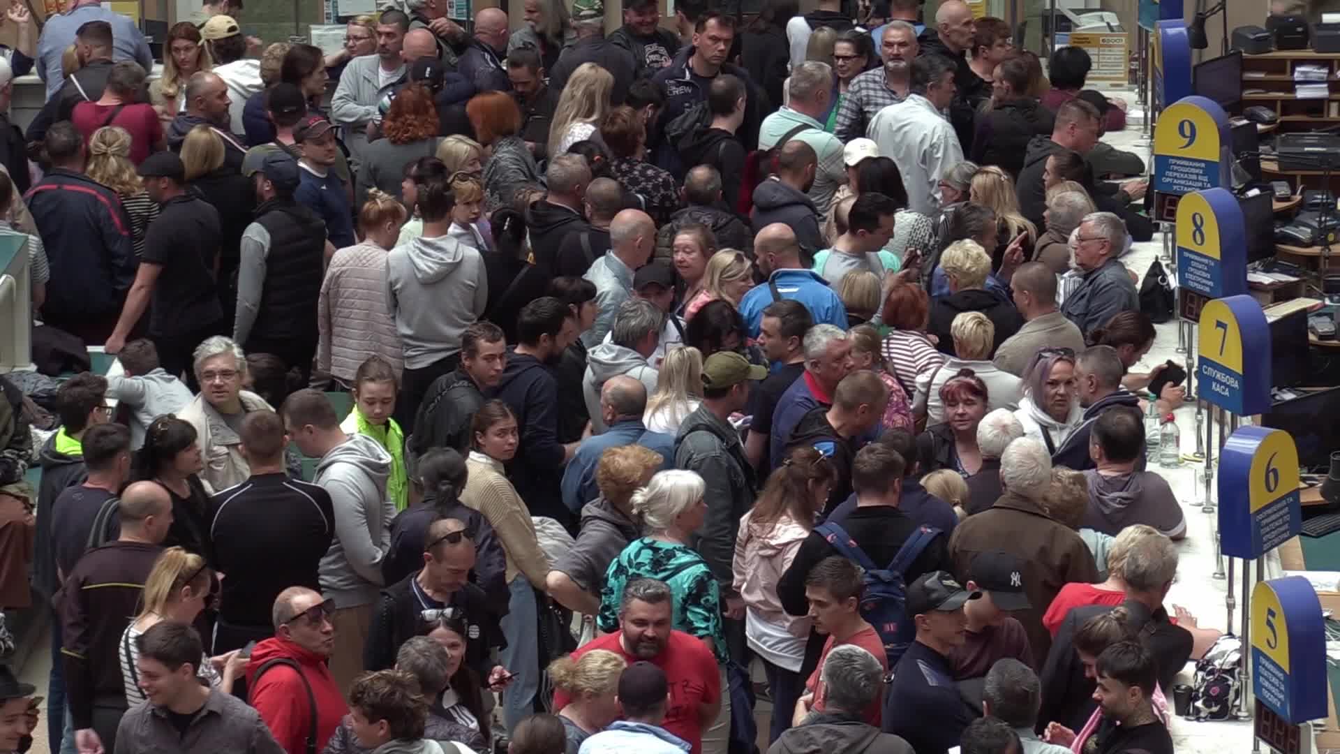 Ukrainians queue to buy a new set of postal service stamps dedicated to the sinking of Russian warship, in Odesa