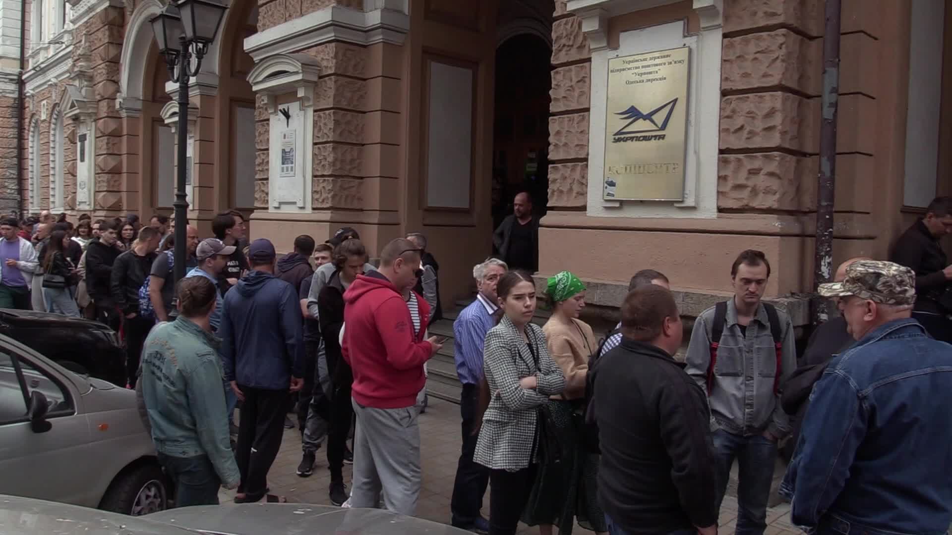 Ukrainians queue to buy a new set of postal service stamps dedicated to the sinking of Russian warship, in Odesa