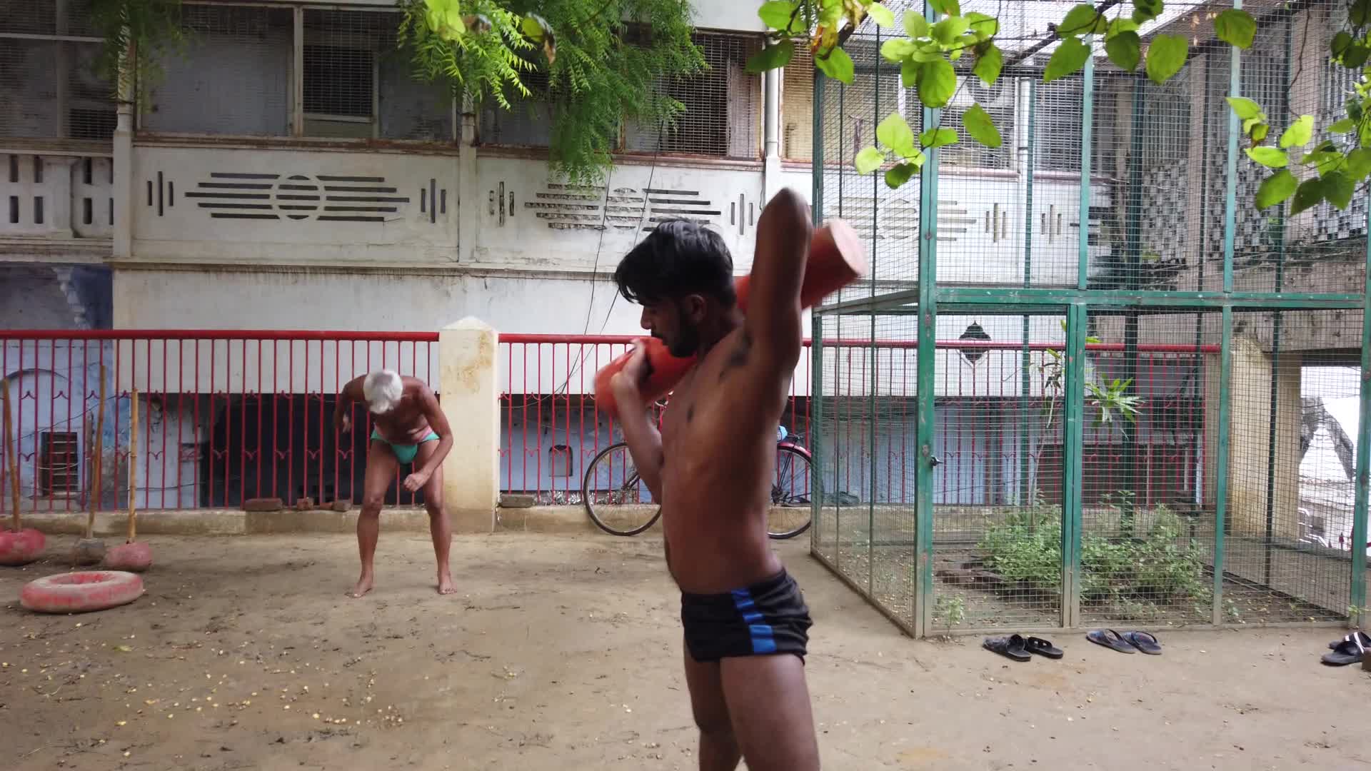 Kushti players doing tradition exercise  with wodden club  at Tulsi Ghat Akhada