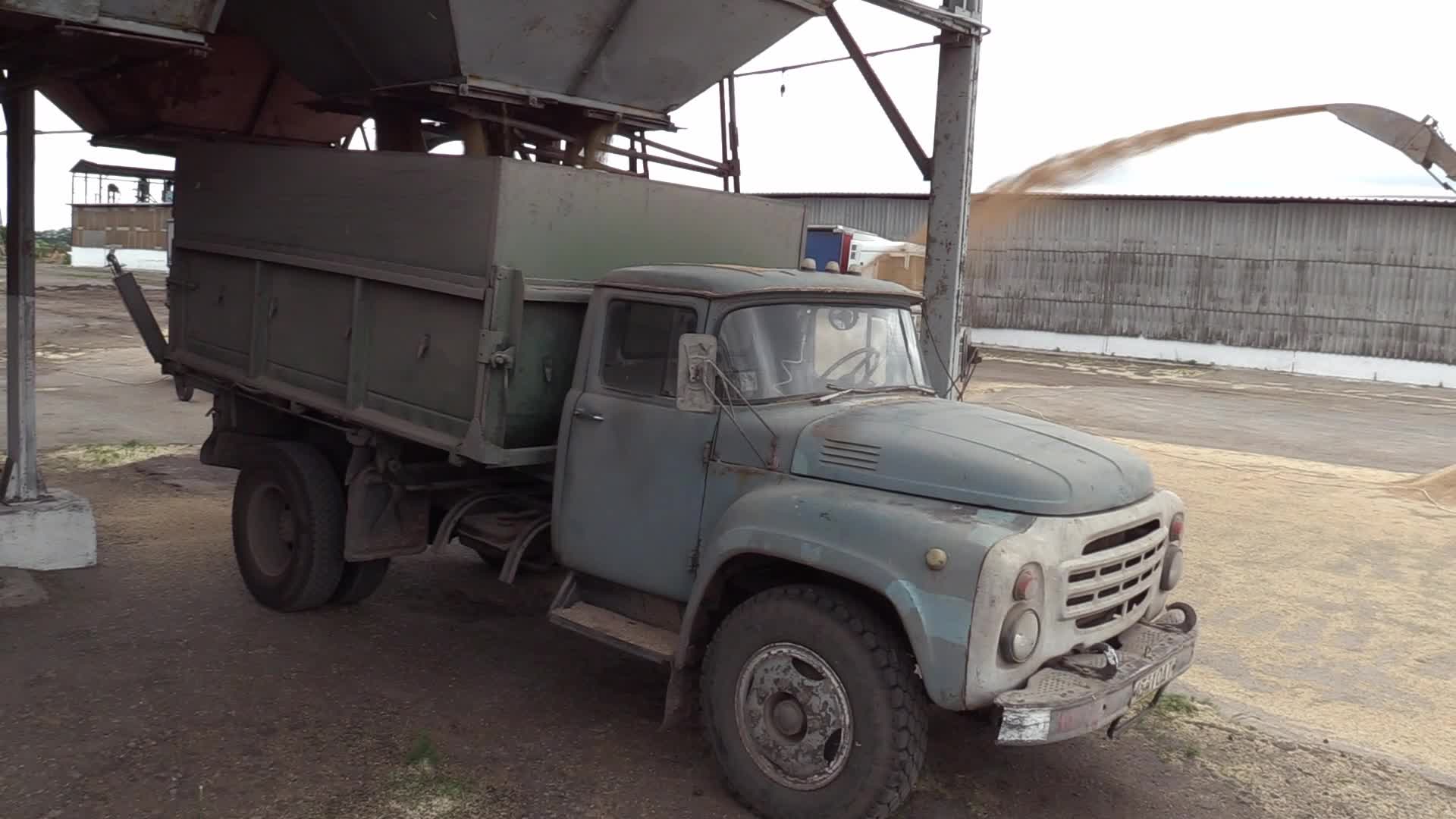 Ukrainian farmers upload barley and wheat grain at a terminal in Odesa region, amid Russia's invasion of Ukraine