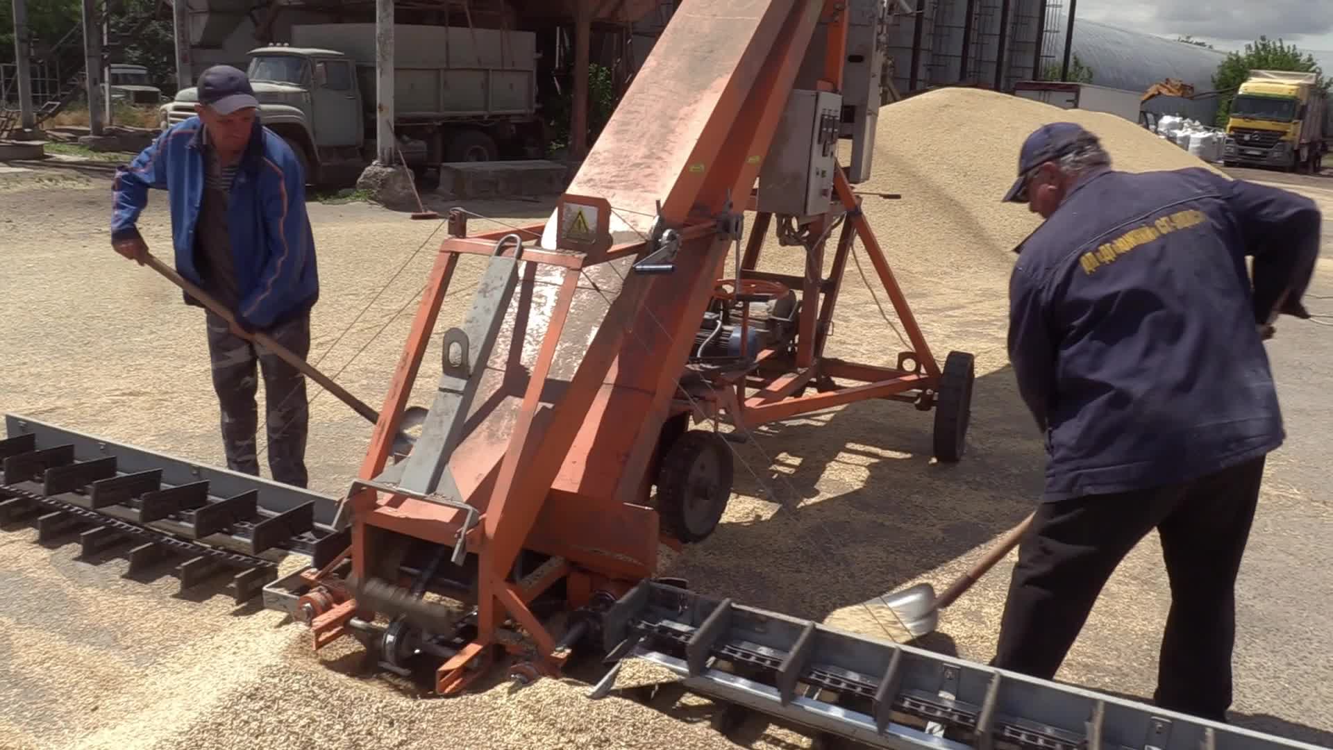 Ukrainian farmers upload barley and wheat grain at a terminal in Odesa region, amid Russia's invasion of Ukraine