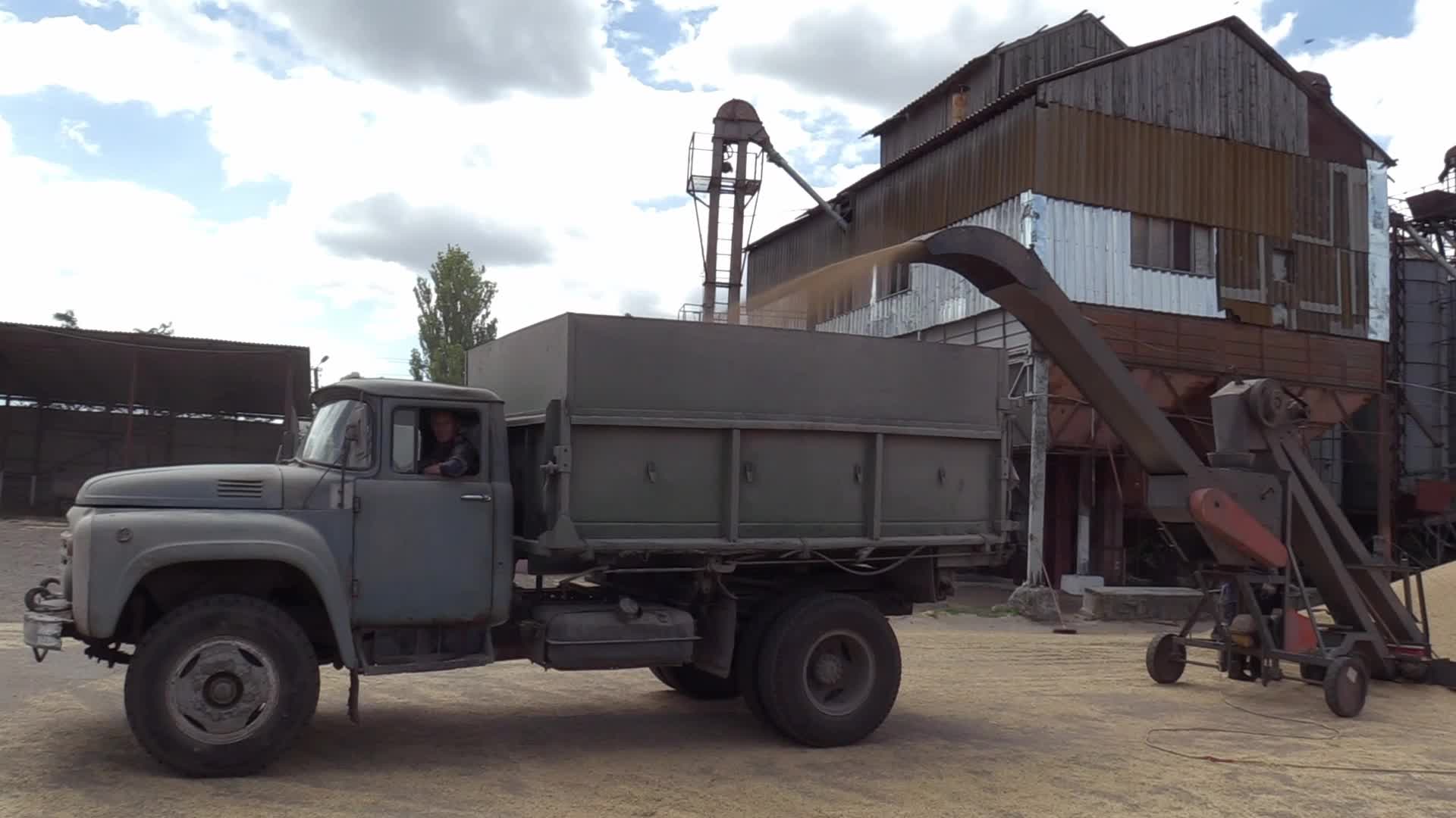 Ukrainian farmers upload barley and wheat grain at a terminal in Odesa region, amid Russia's invasion of Ukraine