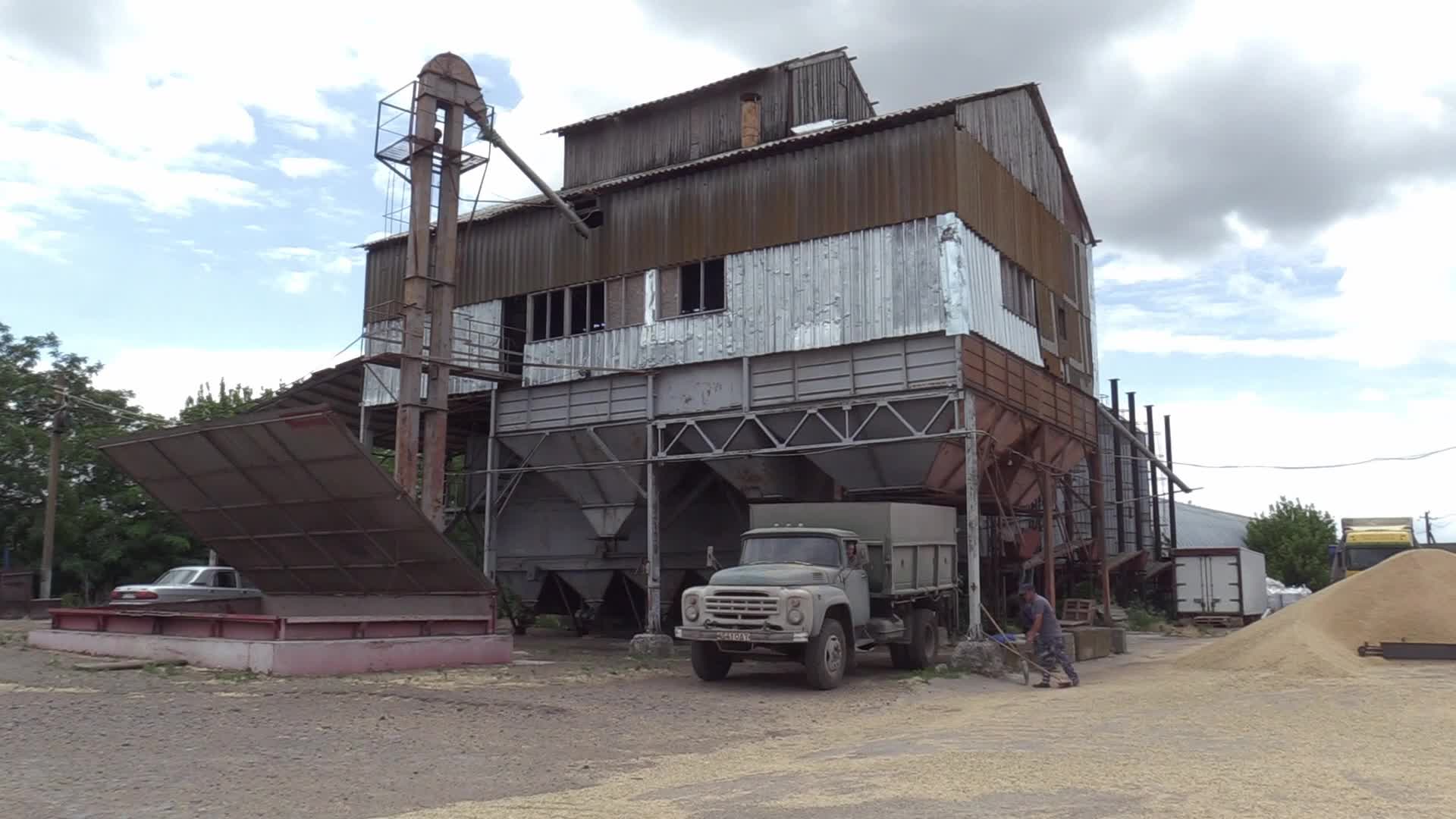 Ukrainian farmers upload barley and wheat grain at a terminal in Odesa region, amid Russia's invasion of Ukraine