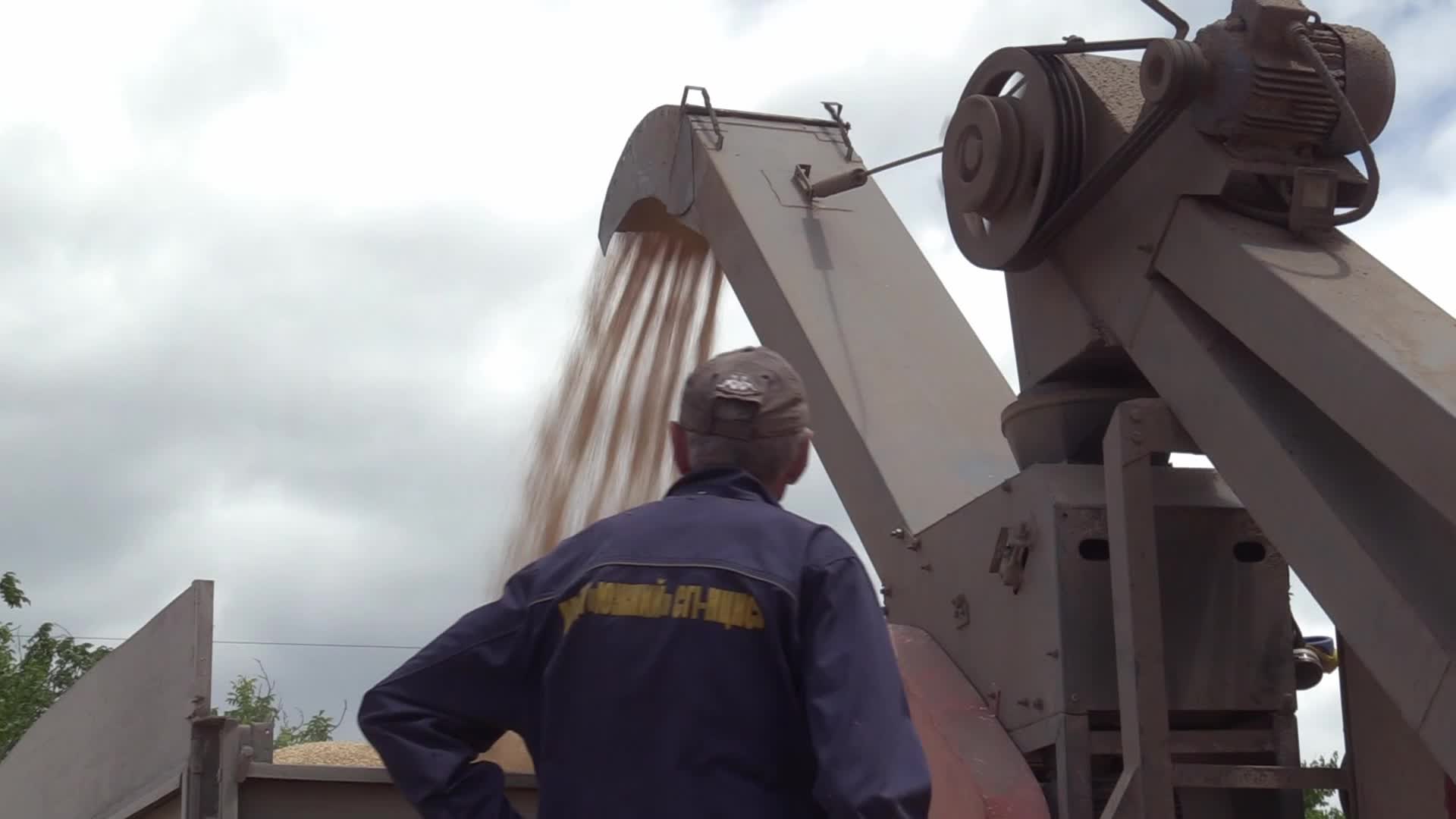 Ukrainian farmers upload barley and wheat grain at a terminal in Odesa region, amid Russia's invasion of Ukraine