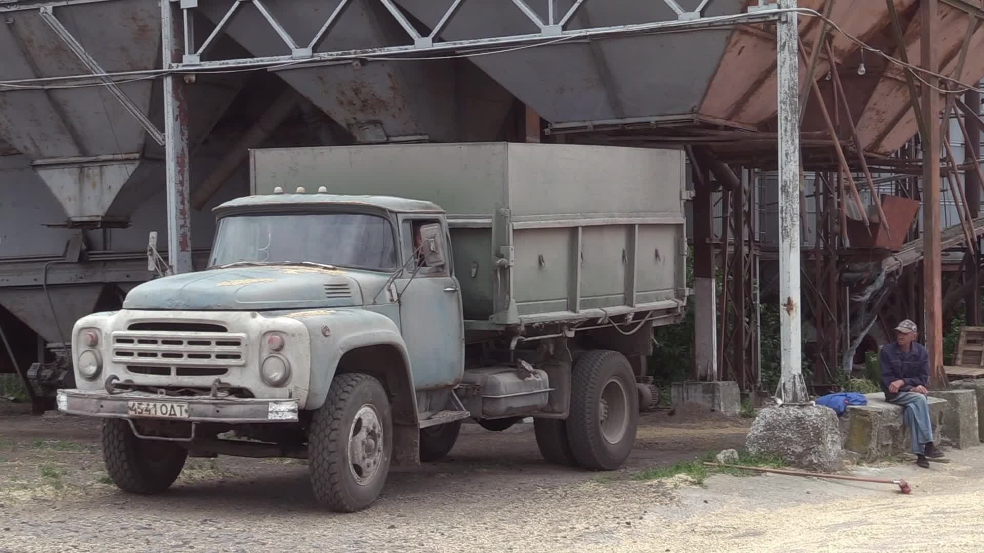 Ukrainian farmers upload barley and wheat grain at a terminal in Odesa region, amid Russia's invasion of Ukraine