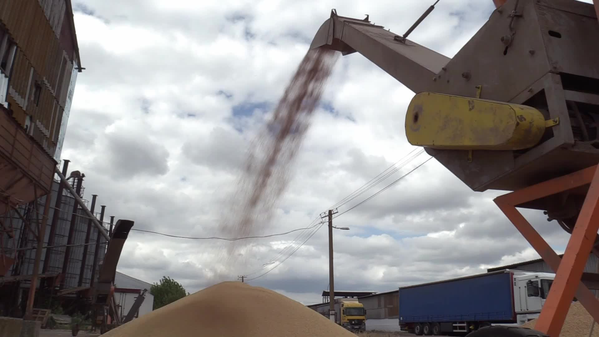 Ukrainian farmers upload barley and wheat grain at a terminal in Odesa region, amid Russia's invasion of Ukraine