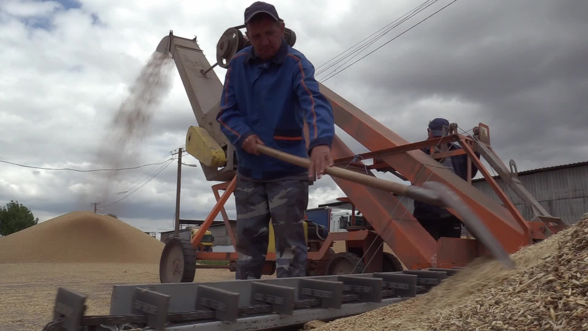Ukrainian farmers upload barley and wheat grain at a terminal in Odesa region, amid Russia's invasion of Ukraine