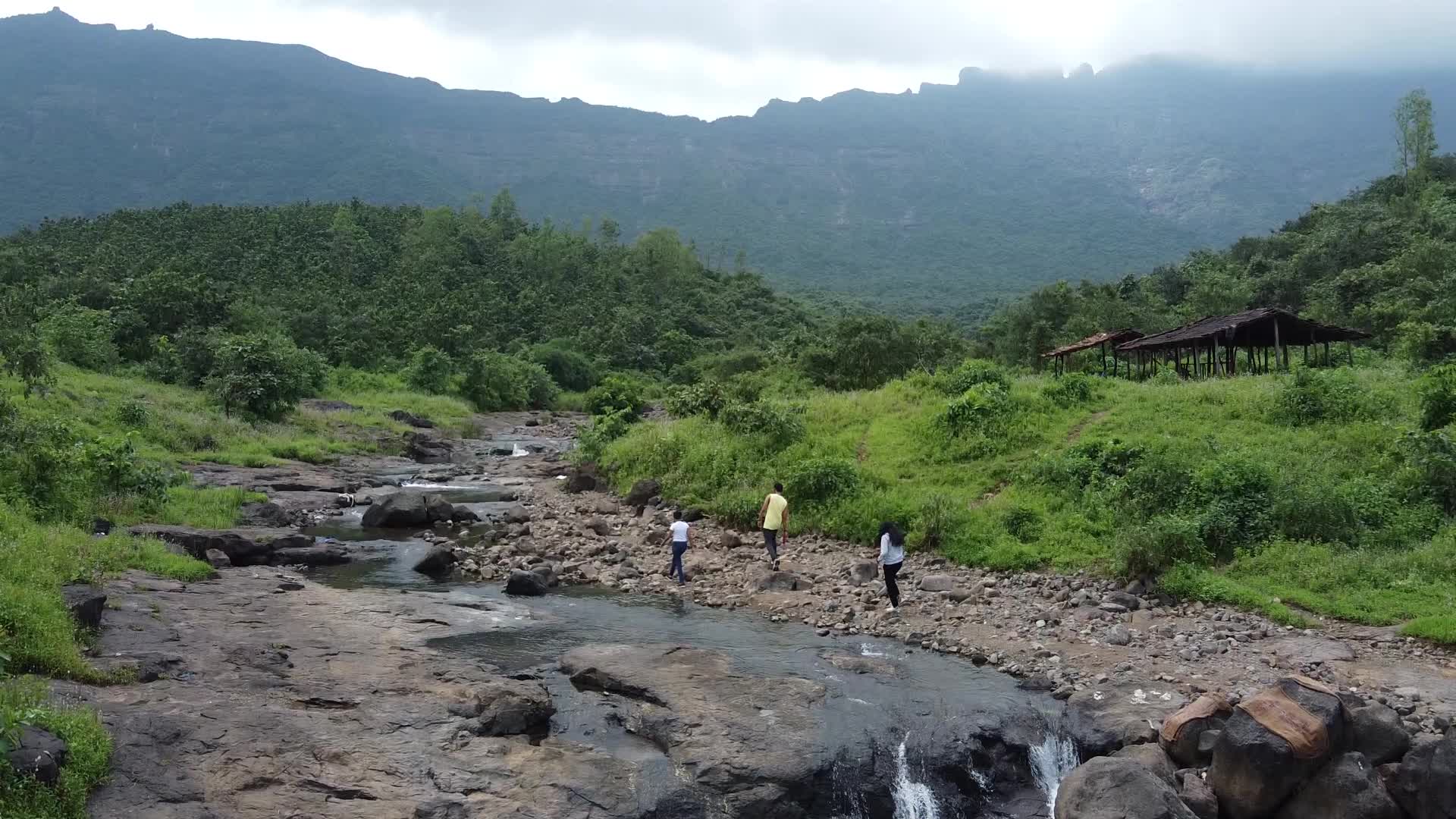 Group of friends enjoying the nature and waterfall