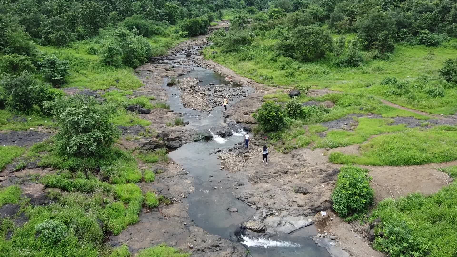 Group of friends enjoying the nature and waterfall