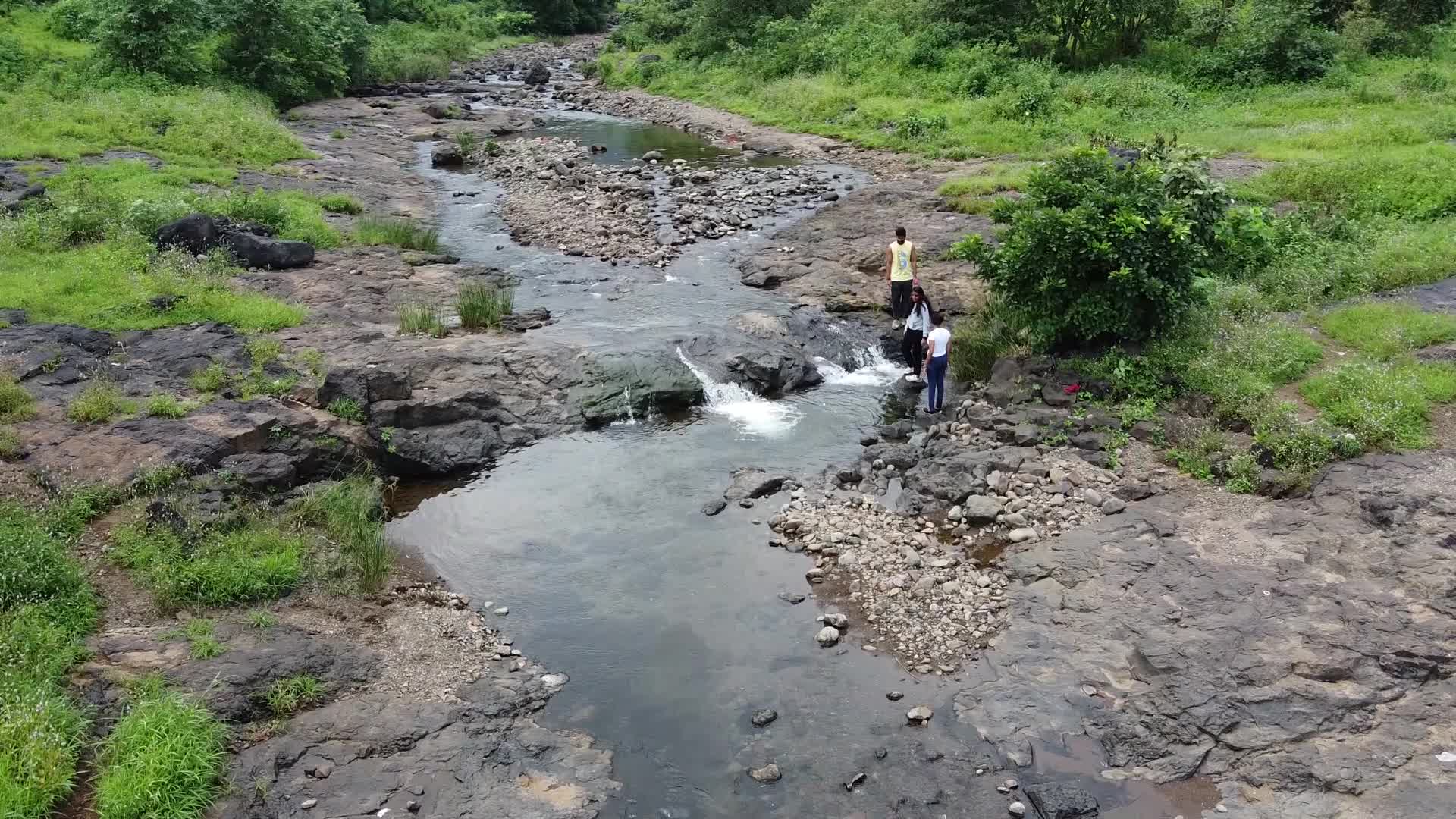 Group of friends enjoying the nature and waterfall