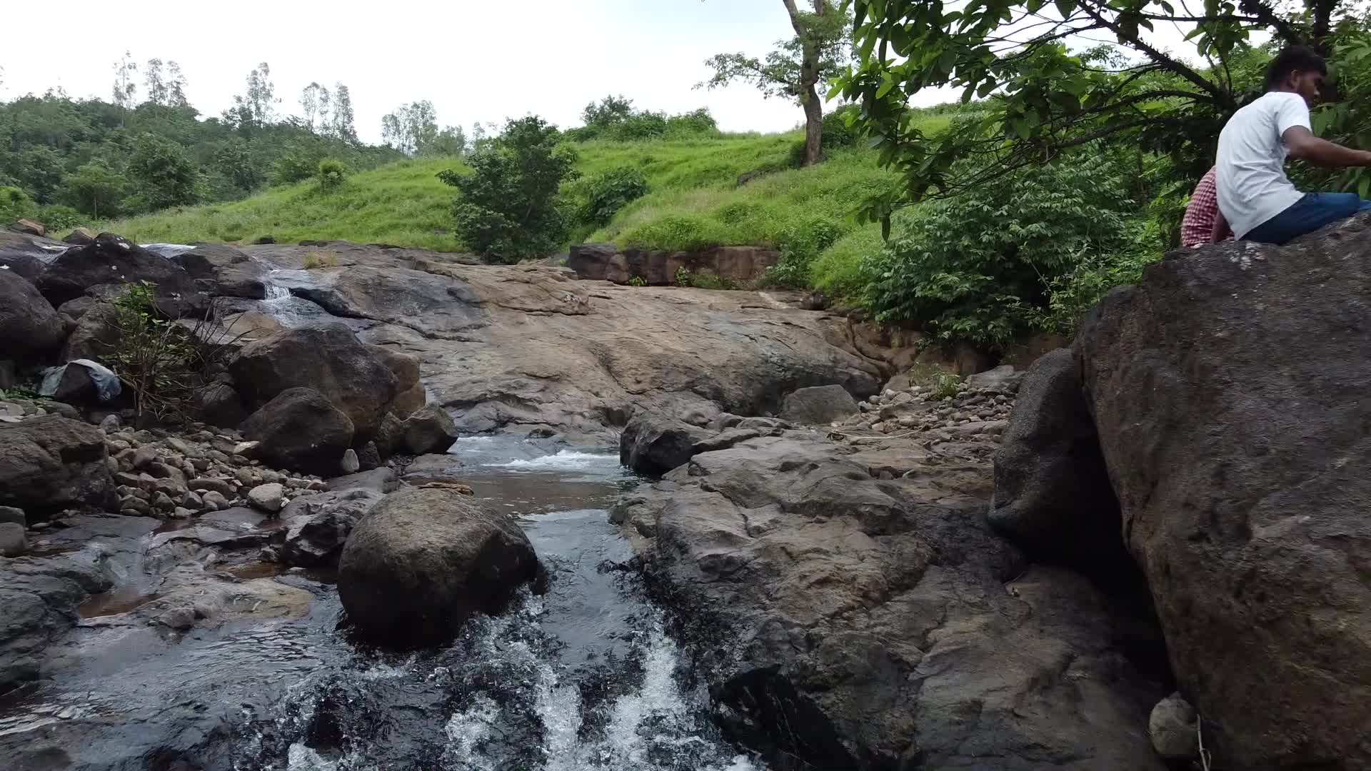 Group of friends enjoying the nature and waterfall