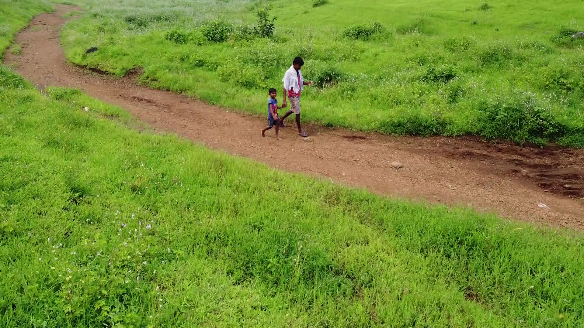 Father and son walking towards there village after days farm work