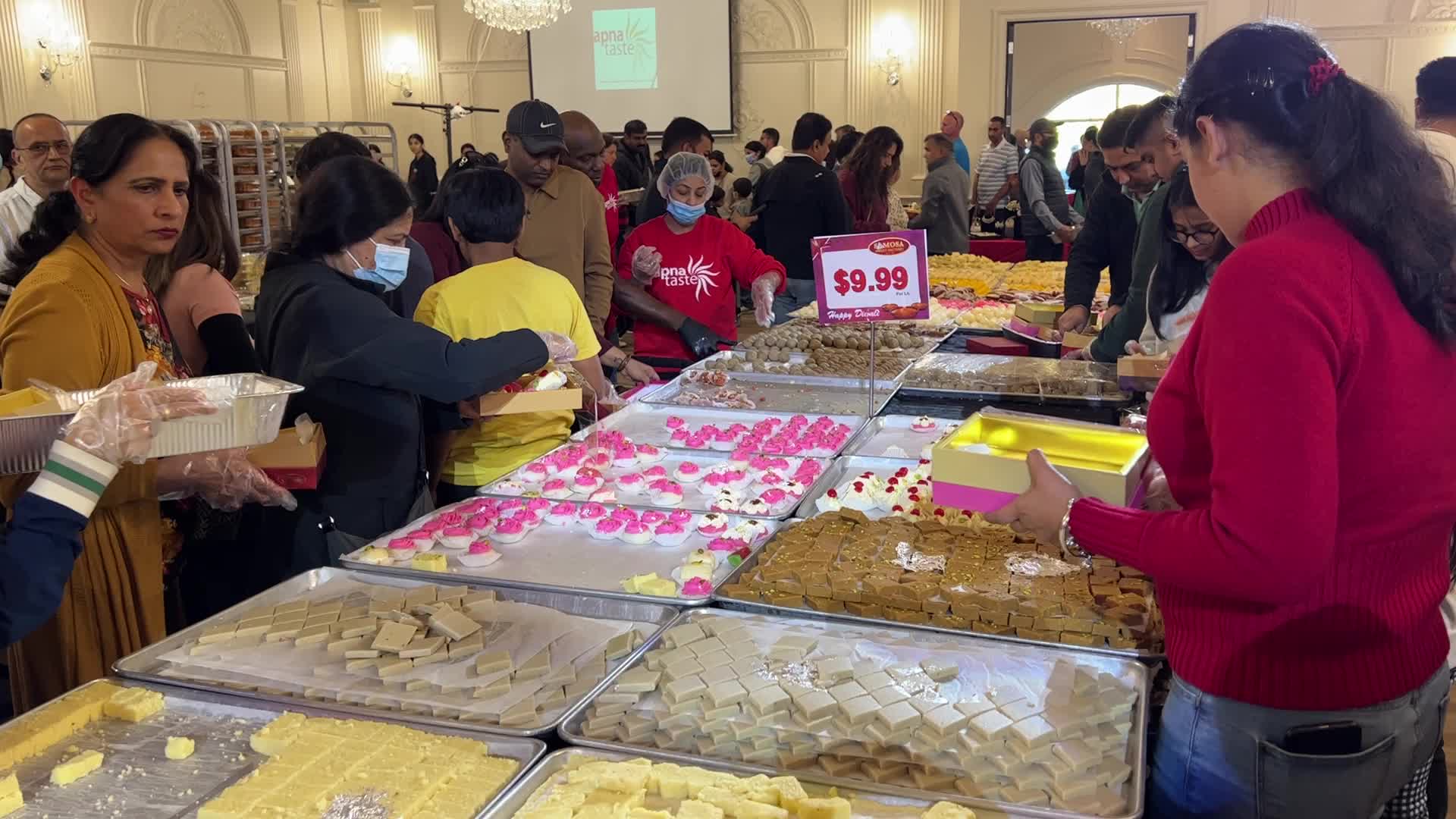 People purchase Indian sweets for the festival of Diwali 