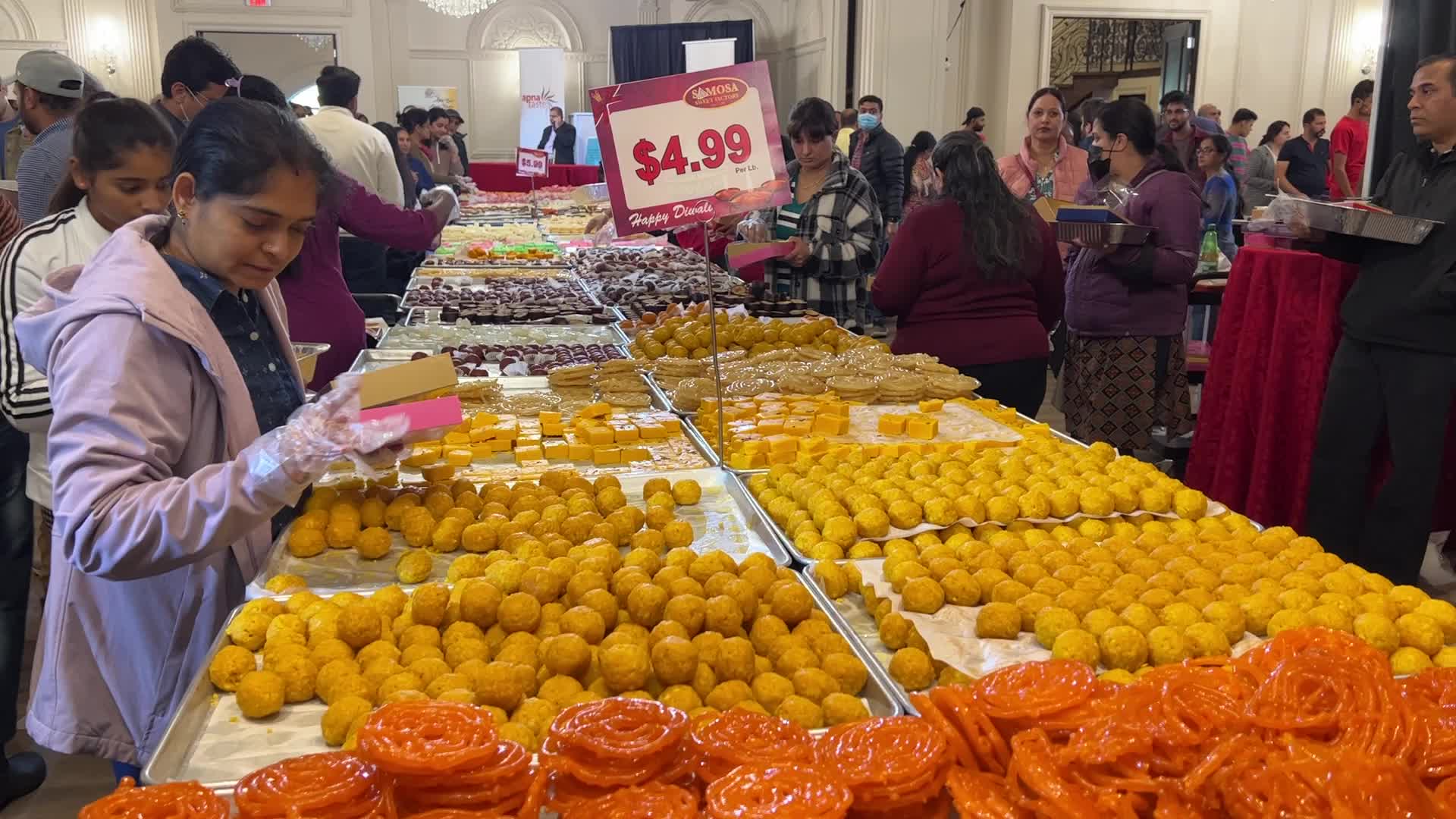 People purchase Indian sweets for the festival of Diwali 