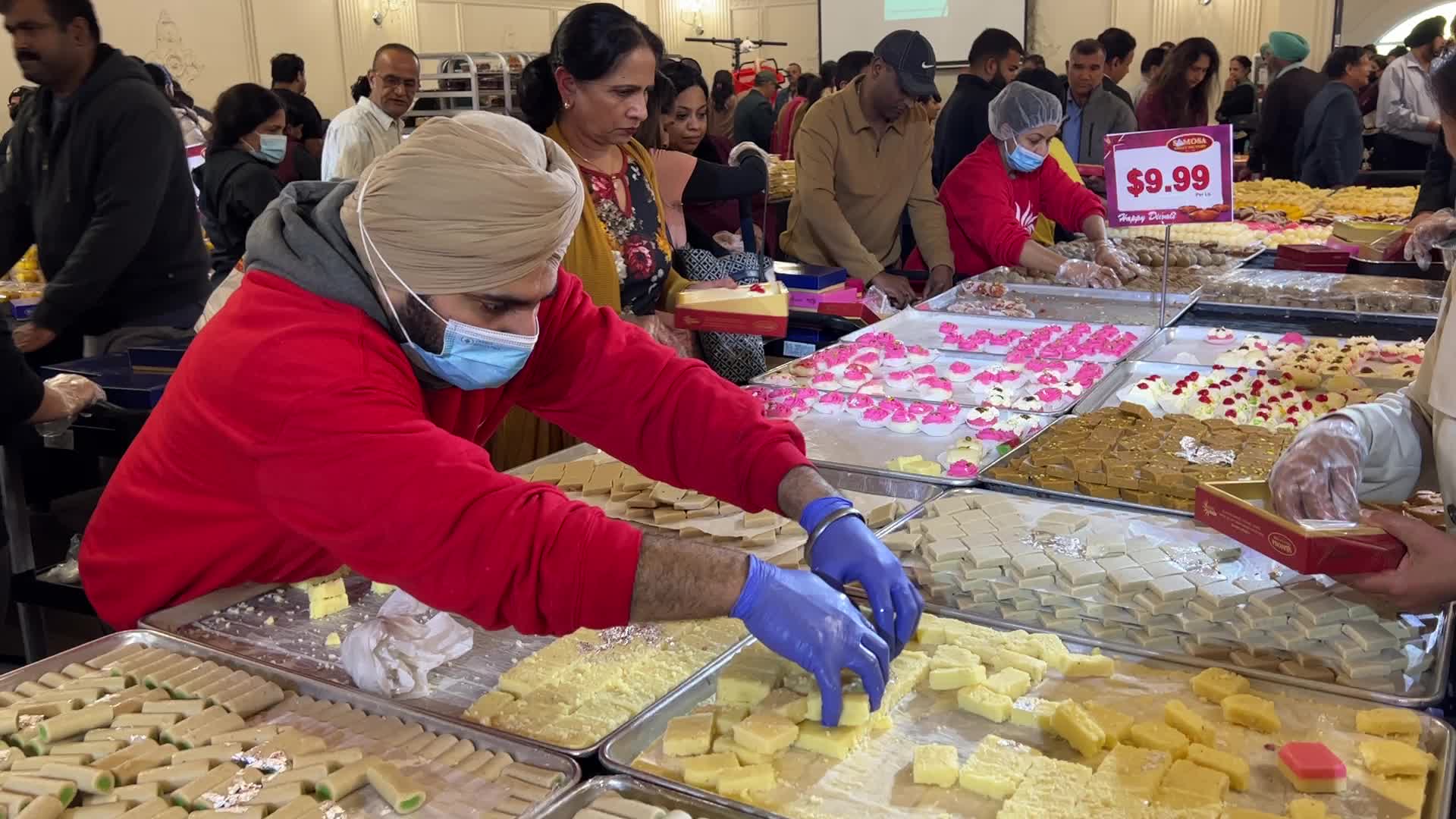 People purchase Indian sweets for the festival of Diwali 