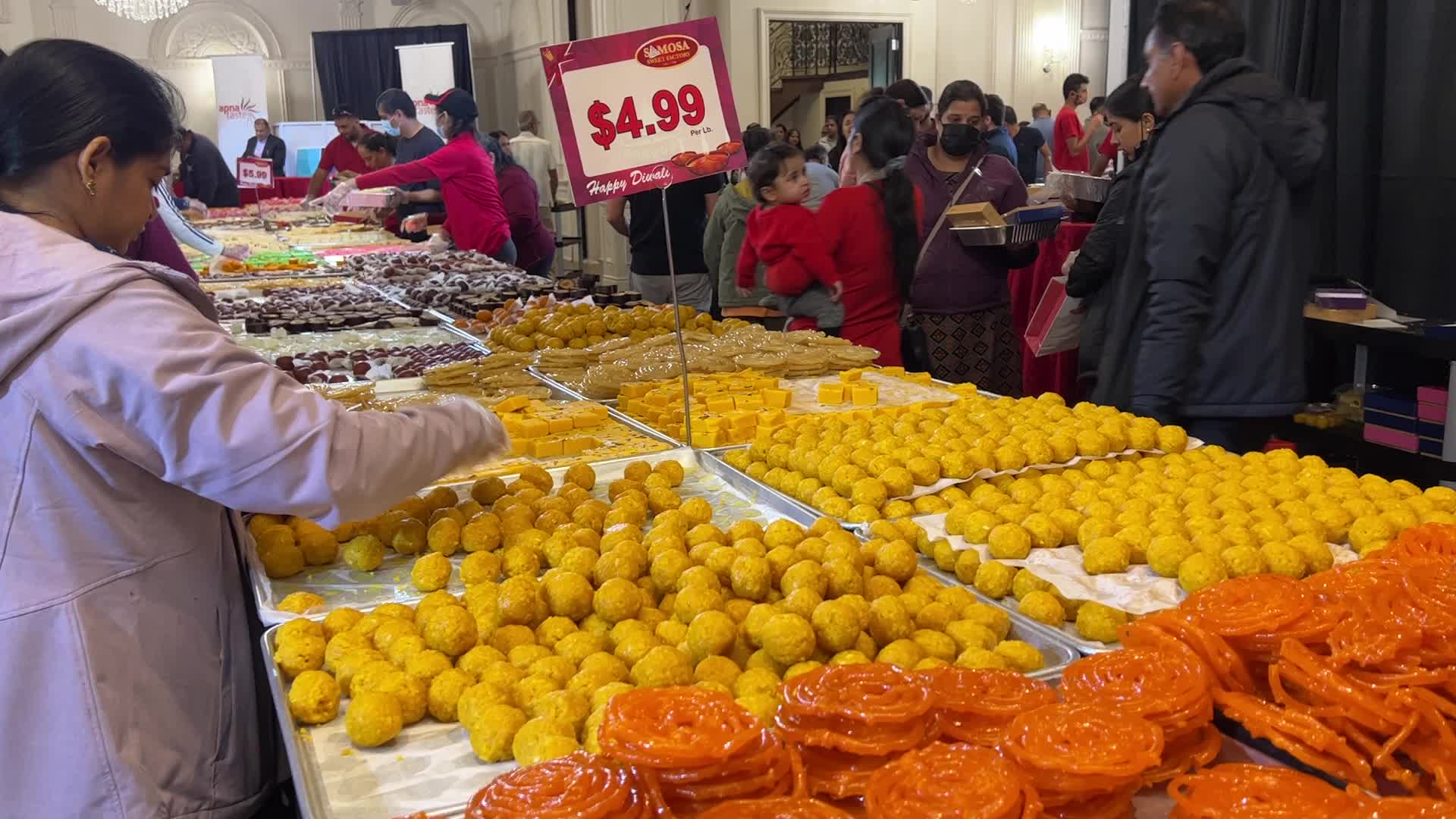People purchase Indian sweets for the festival of Diwali 