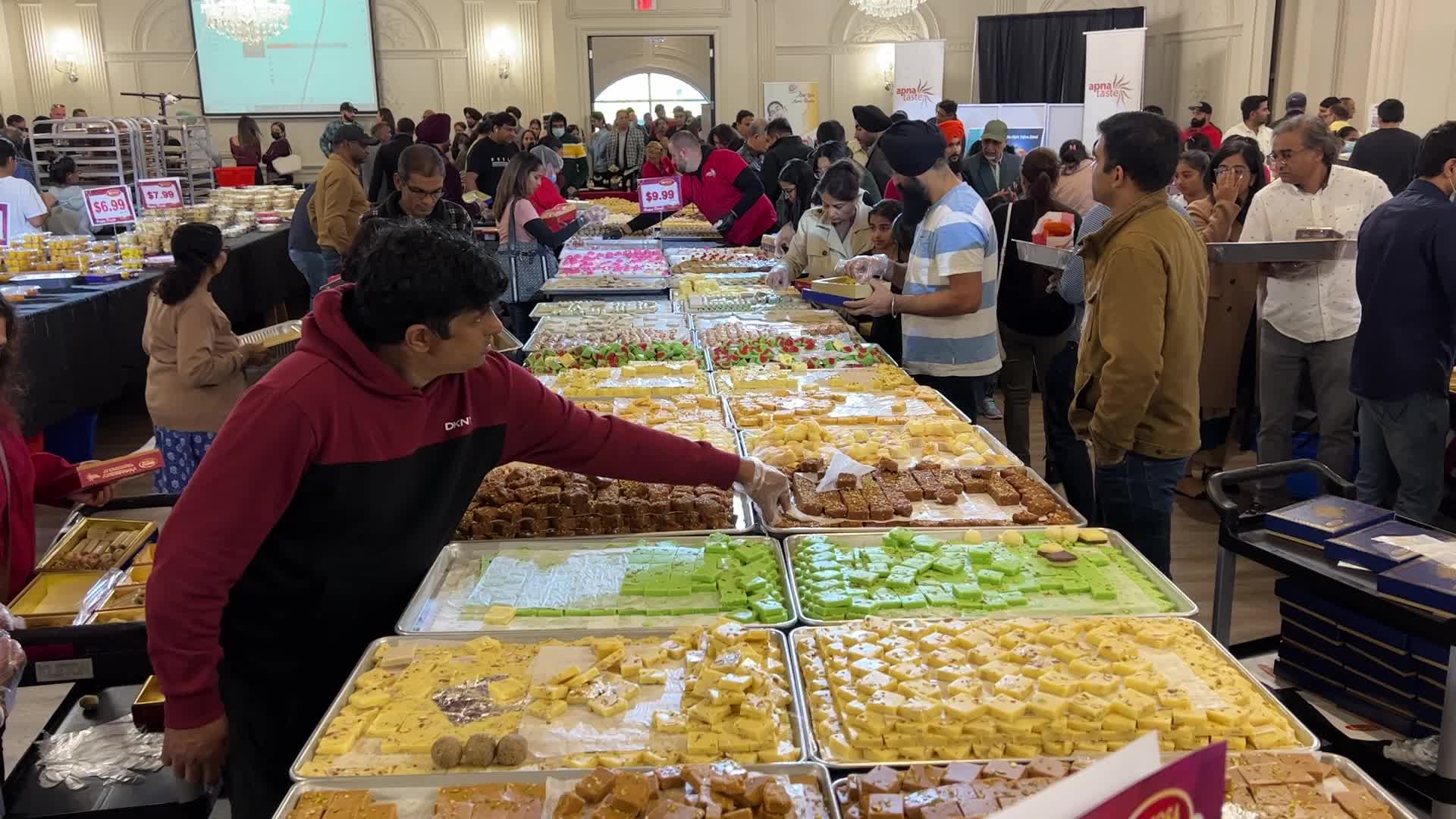 People purchase Indian sweets for the festival of Diwali 