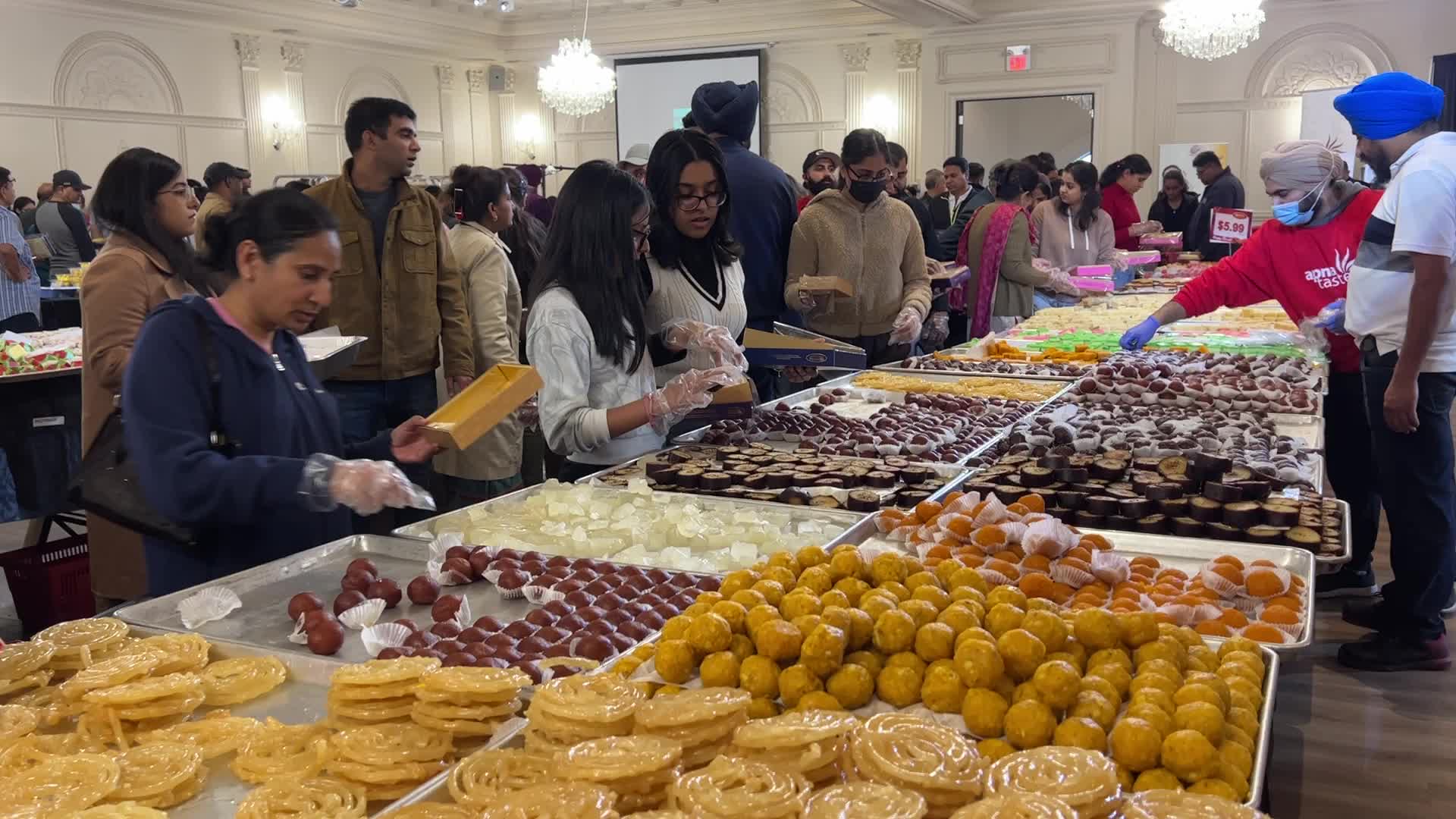 People purchase Indian sweets for the festival of Diwali 