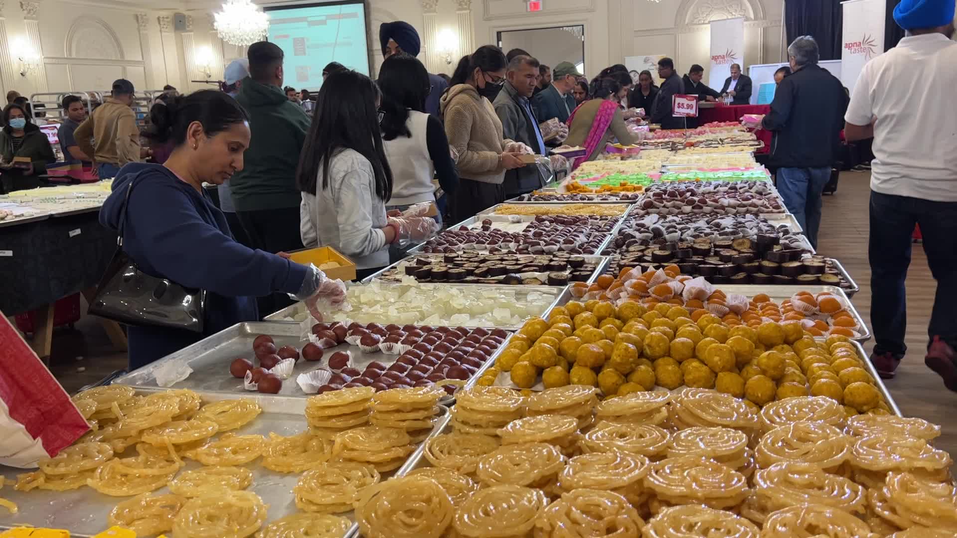 People purchase Indian sweets for the festival of Diwali 