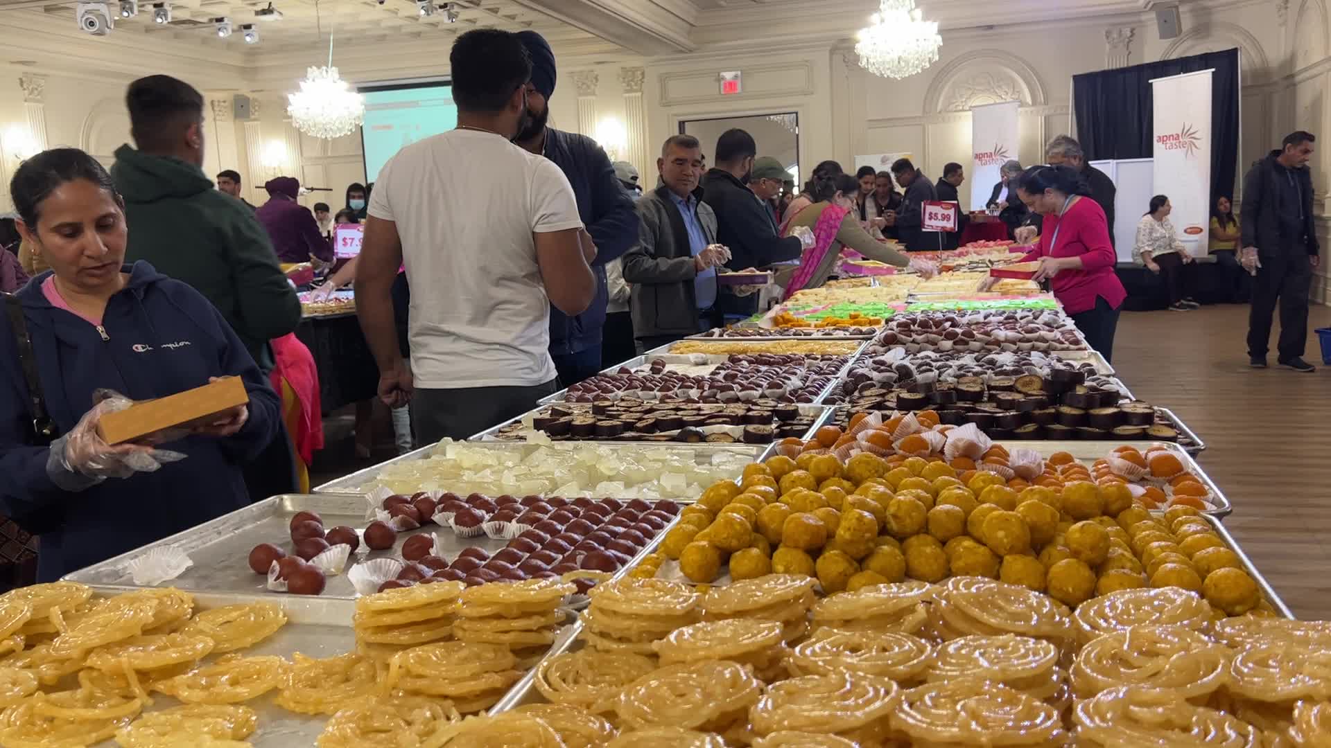 People purchase Indian sweets for the festival of Diwali 