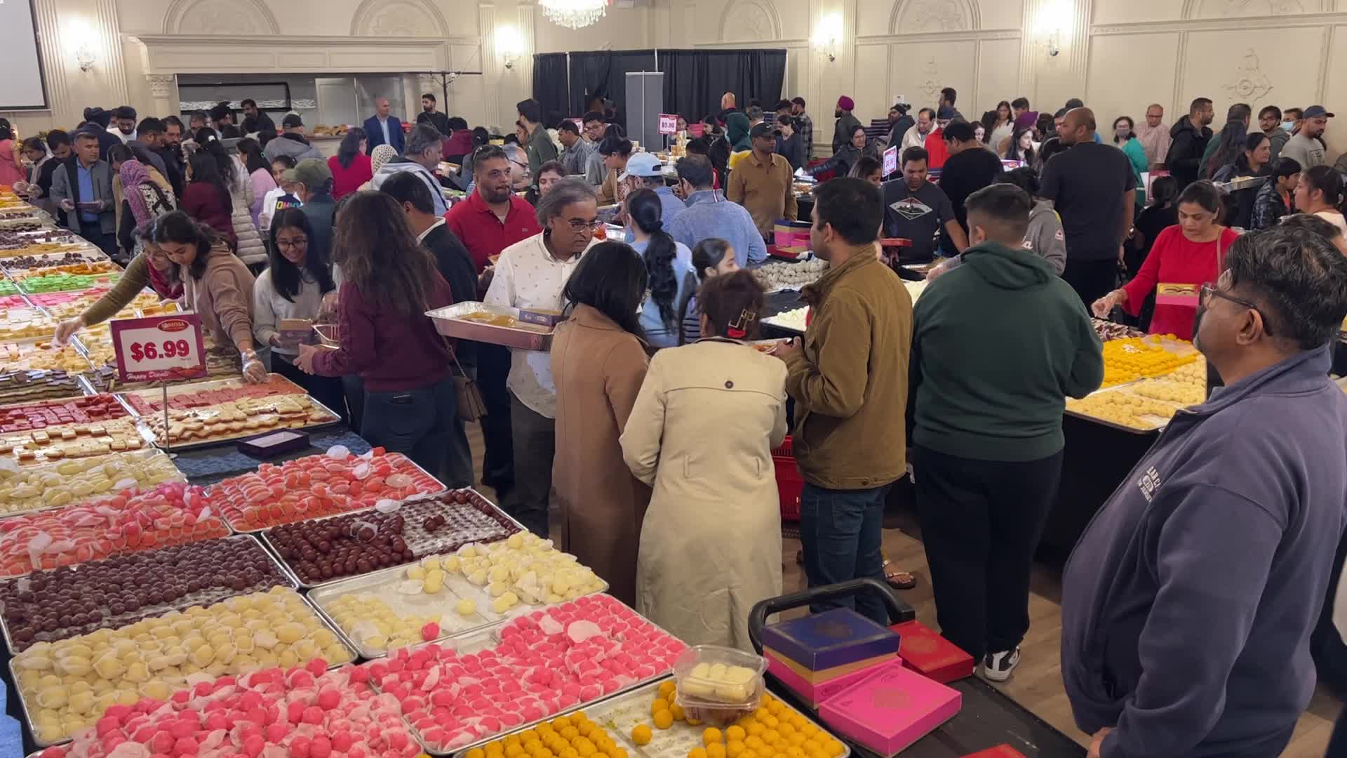 People purchase Indian sweets for the festival of Diwali 