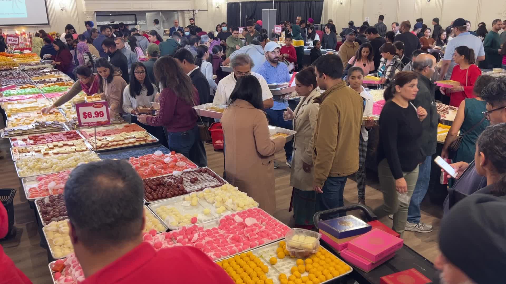 People purchase Indian sweets for the festival of Diwali 