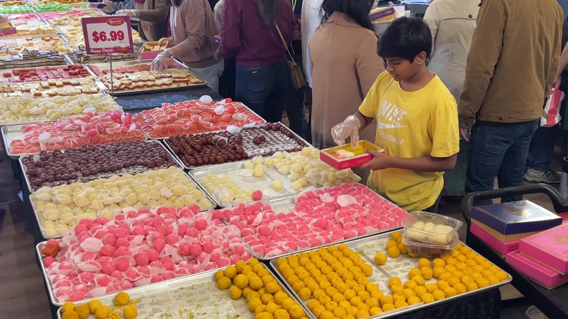 People purchase Indian sweets for the festival of Diwali 