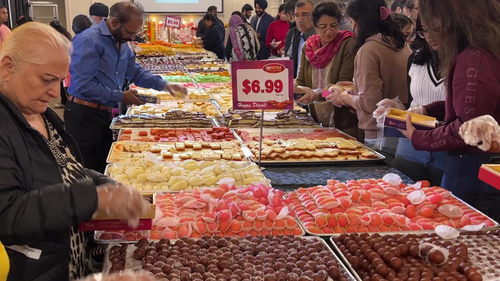 People purchase Indian sweets for the festival of Diwali 