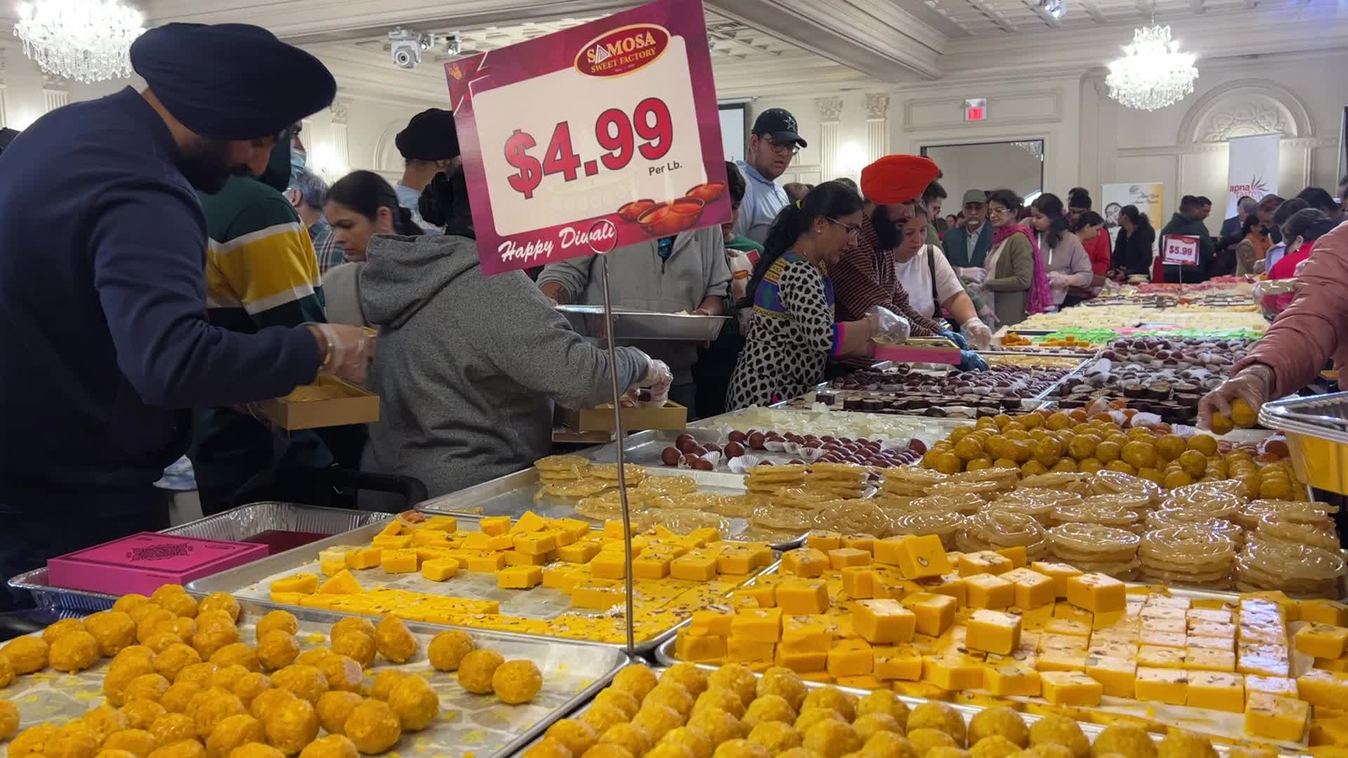 People purchase Indian sweets for the festival of Diwali 