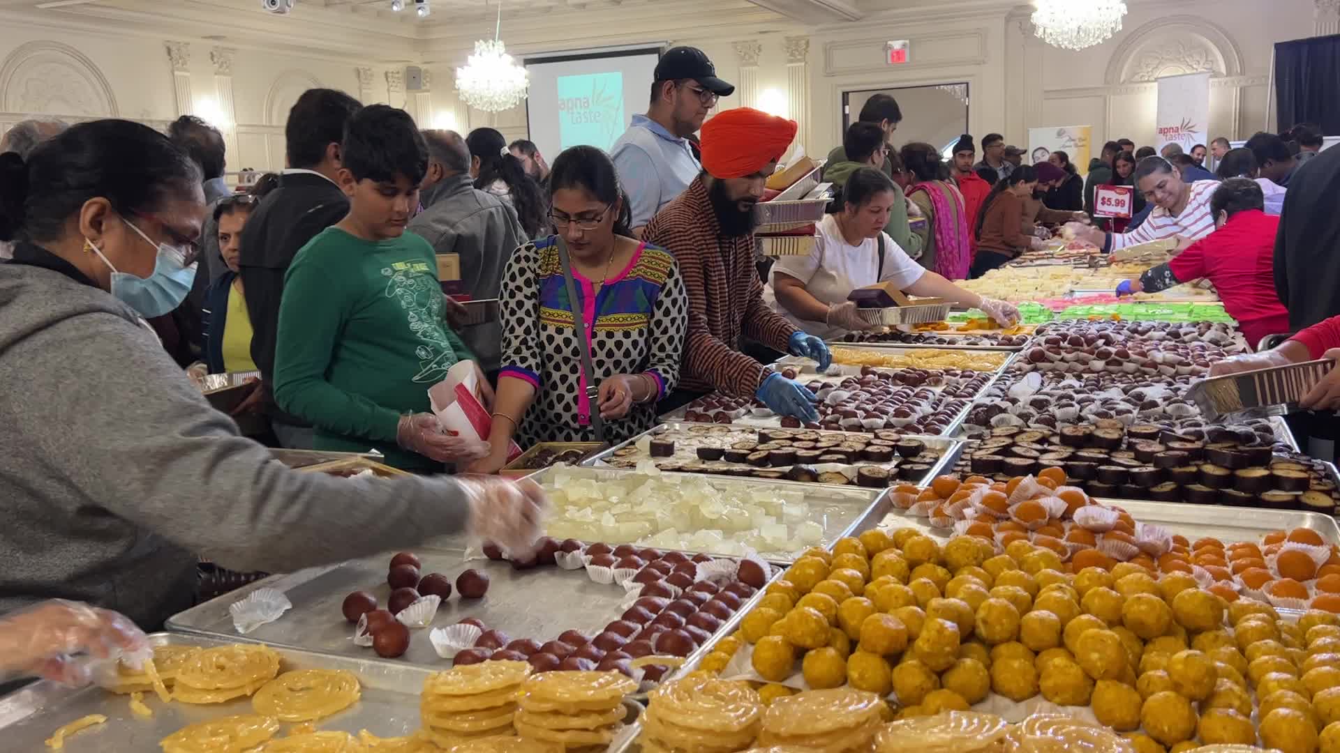 People purchase Indian sweets for the festival of Diwali 