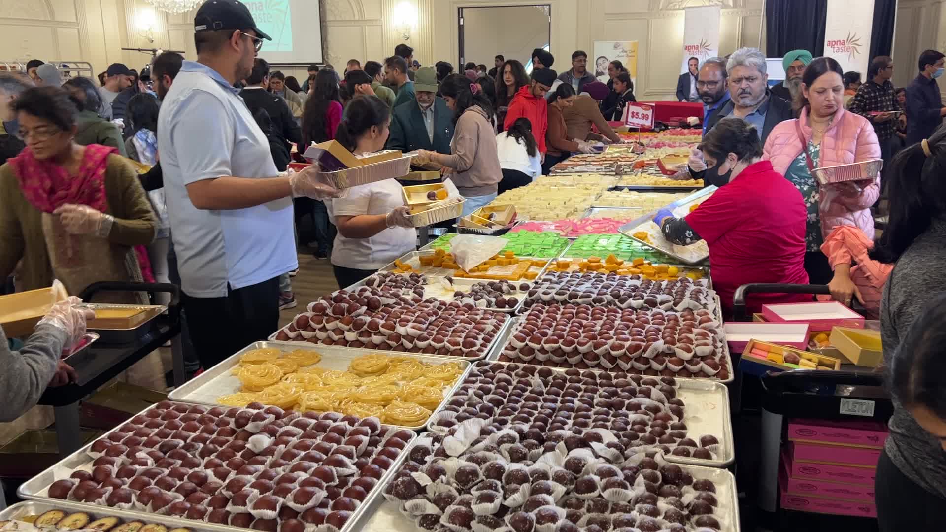 People purchase Indian sweets for the festival of Diwali 