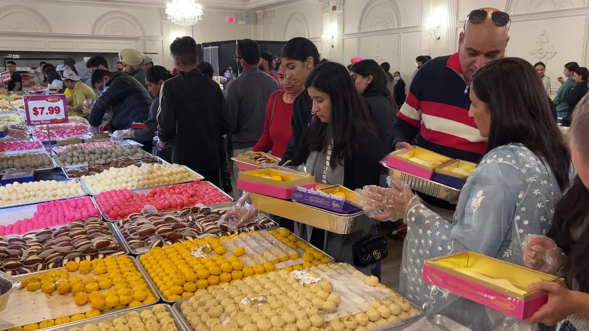 People purchase Indian sweets for the festival of Diwali 