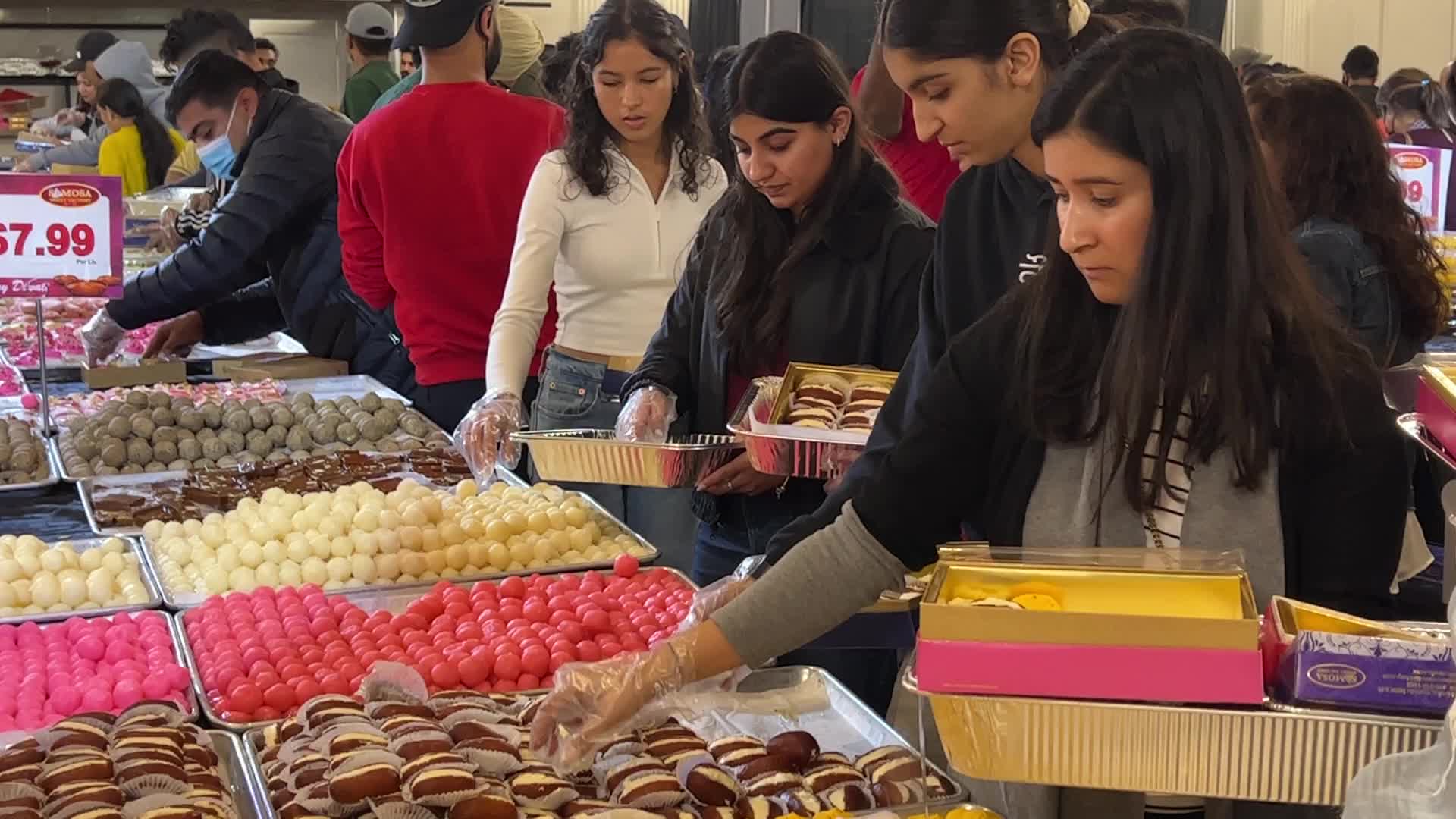 People purchase Indian sweets for the festival of Diwali 