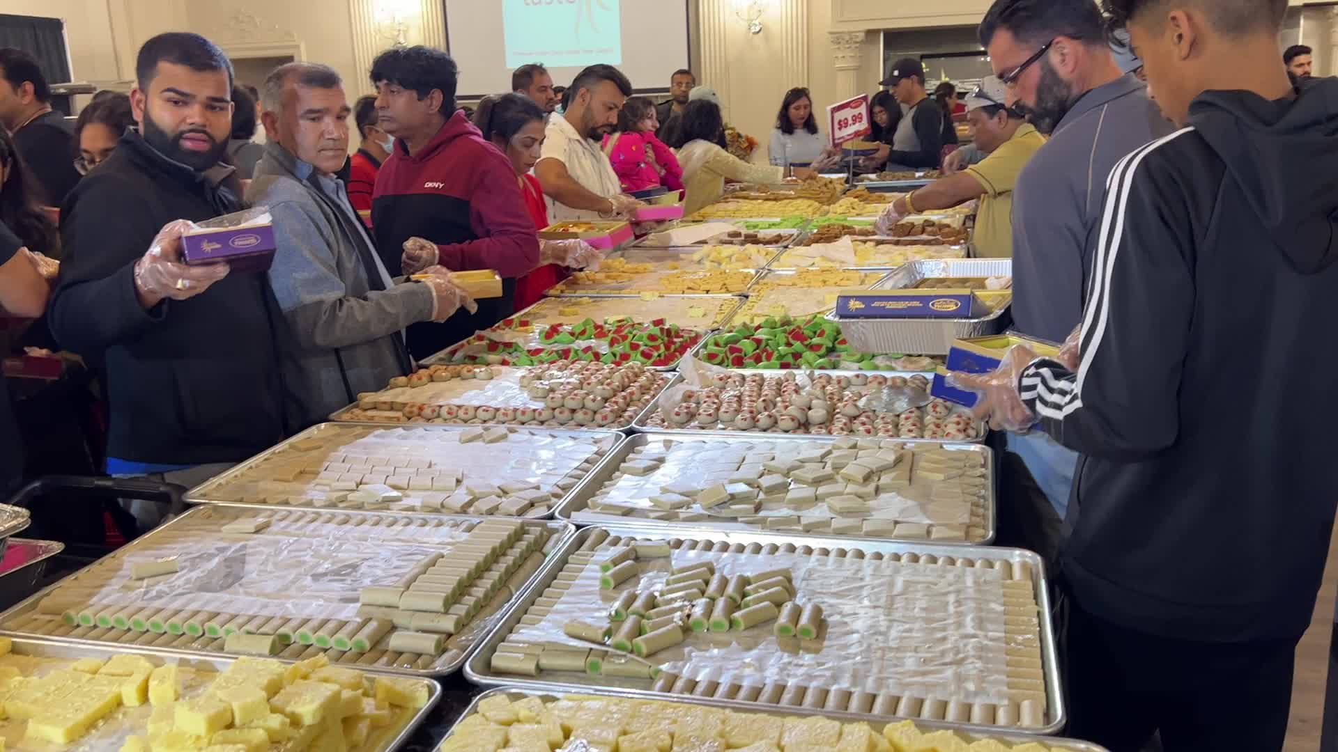 People purchase Indian sweets for the festival of Diwali 