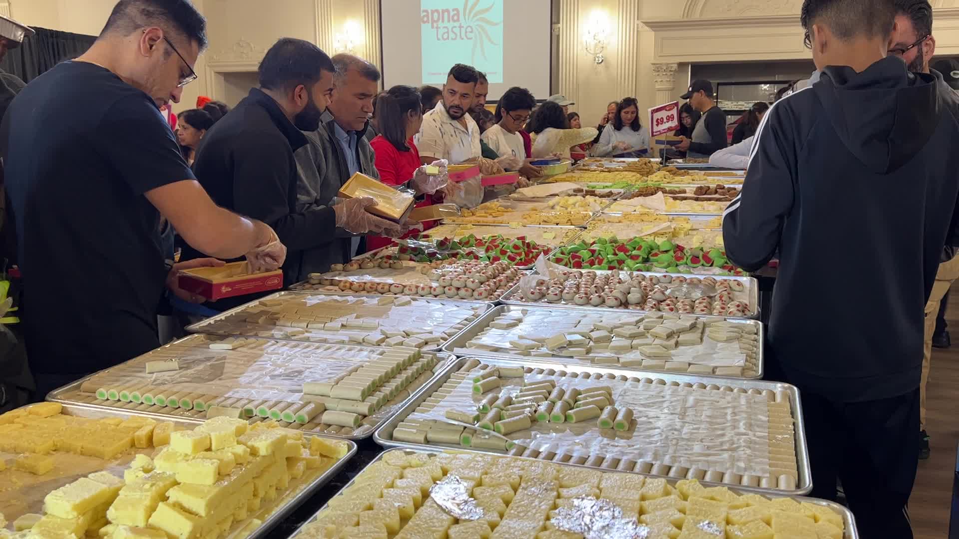 People purchase Indian sweets for the festival of Diwali 