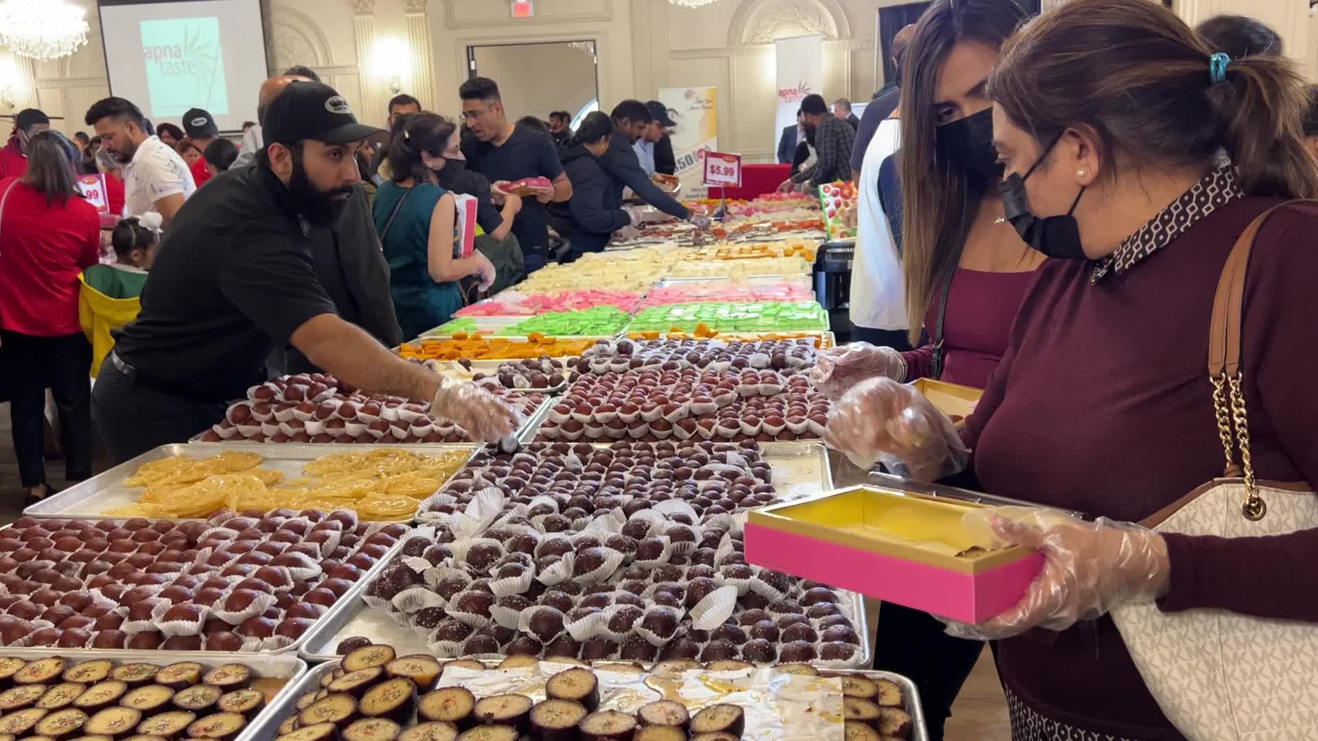 People purchase Indian sweets for the festival of Diwali 