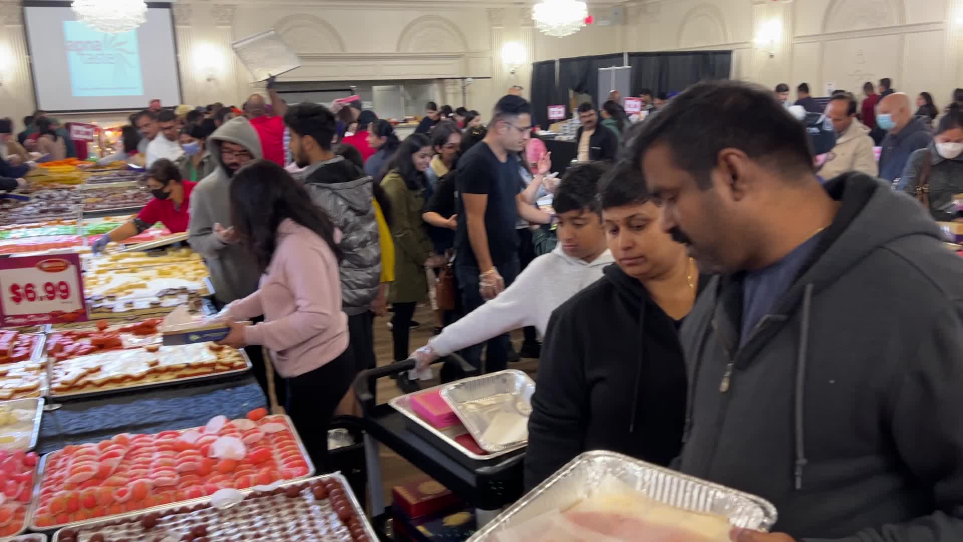 People purchase Indian sweets for the festival of Diwali 