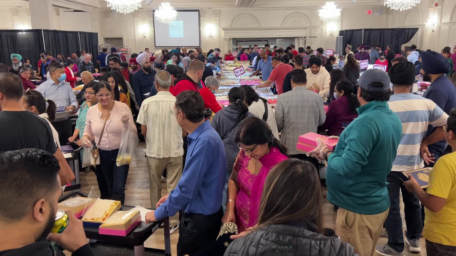 People purchase Indian sweets for the festival of Diwali 