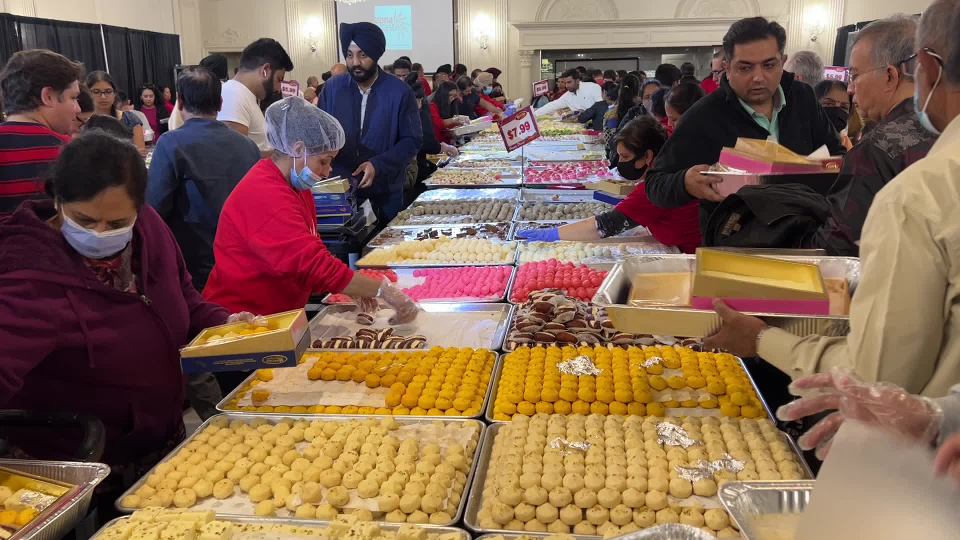 People purchase Indian sweets for the festival of Diwali 
