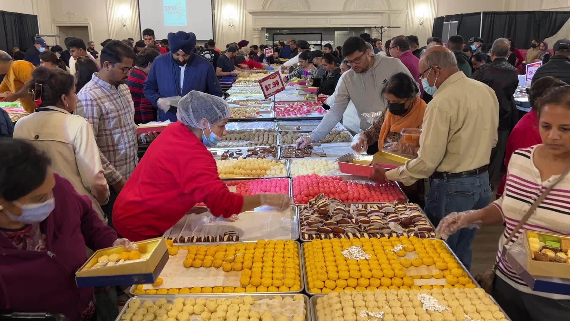 People purchase Indian sweets for the festival of Diwali 