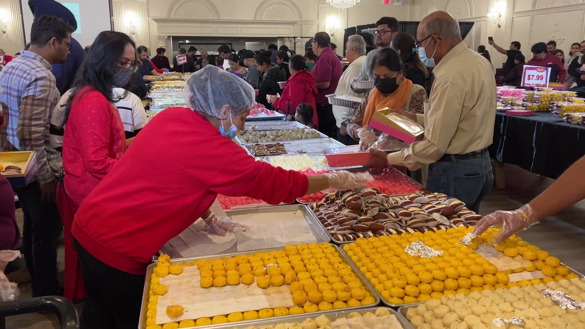People purchase Indian sweets for the festival of Diwali 